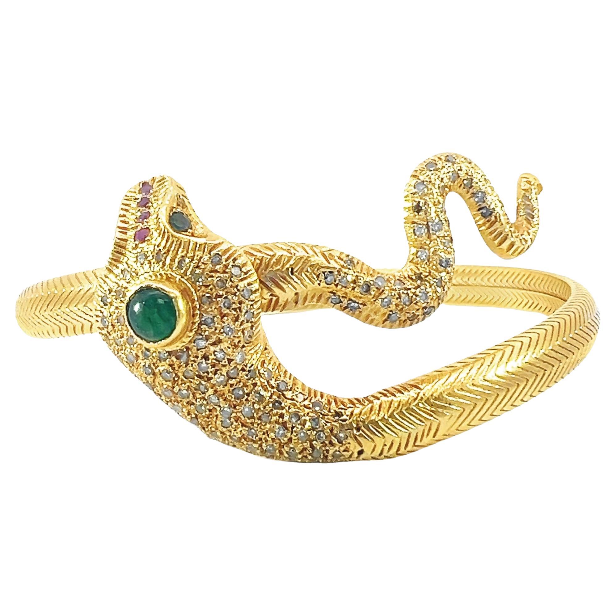 Beautiful solid gold serpent bangle with diamond, emerald and ruby