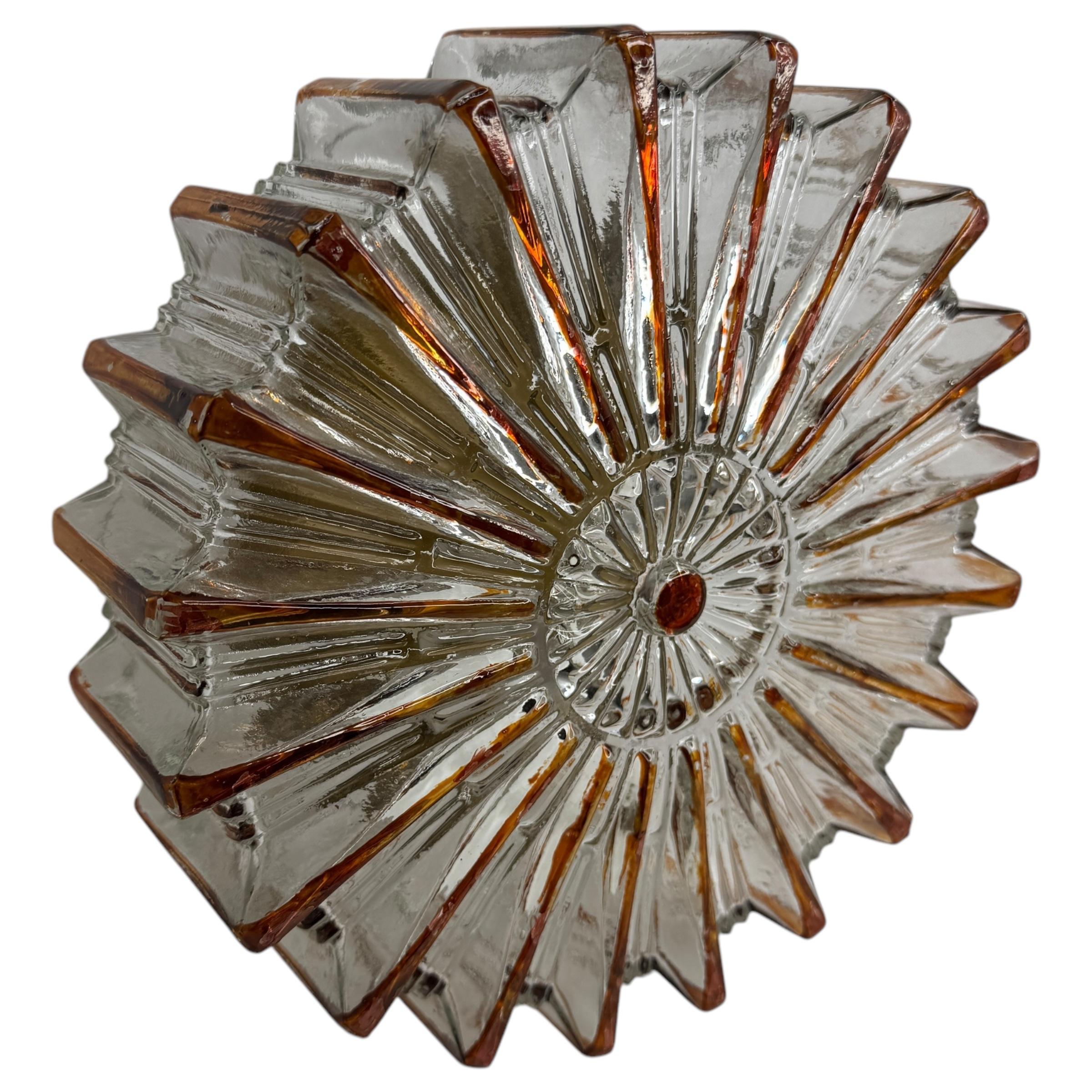 Beautiful starburst pattern flush mount. Made in Germany by Glashuette Limburg. Gorgeous textured glass flush mount with metal fixture. The fixture requires one European E27 Edison bulb up to 75 watts.
Found at an Estate Sale in Nuremberg, Germany.