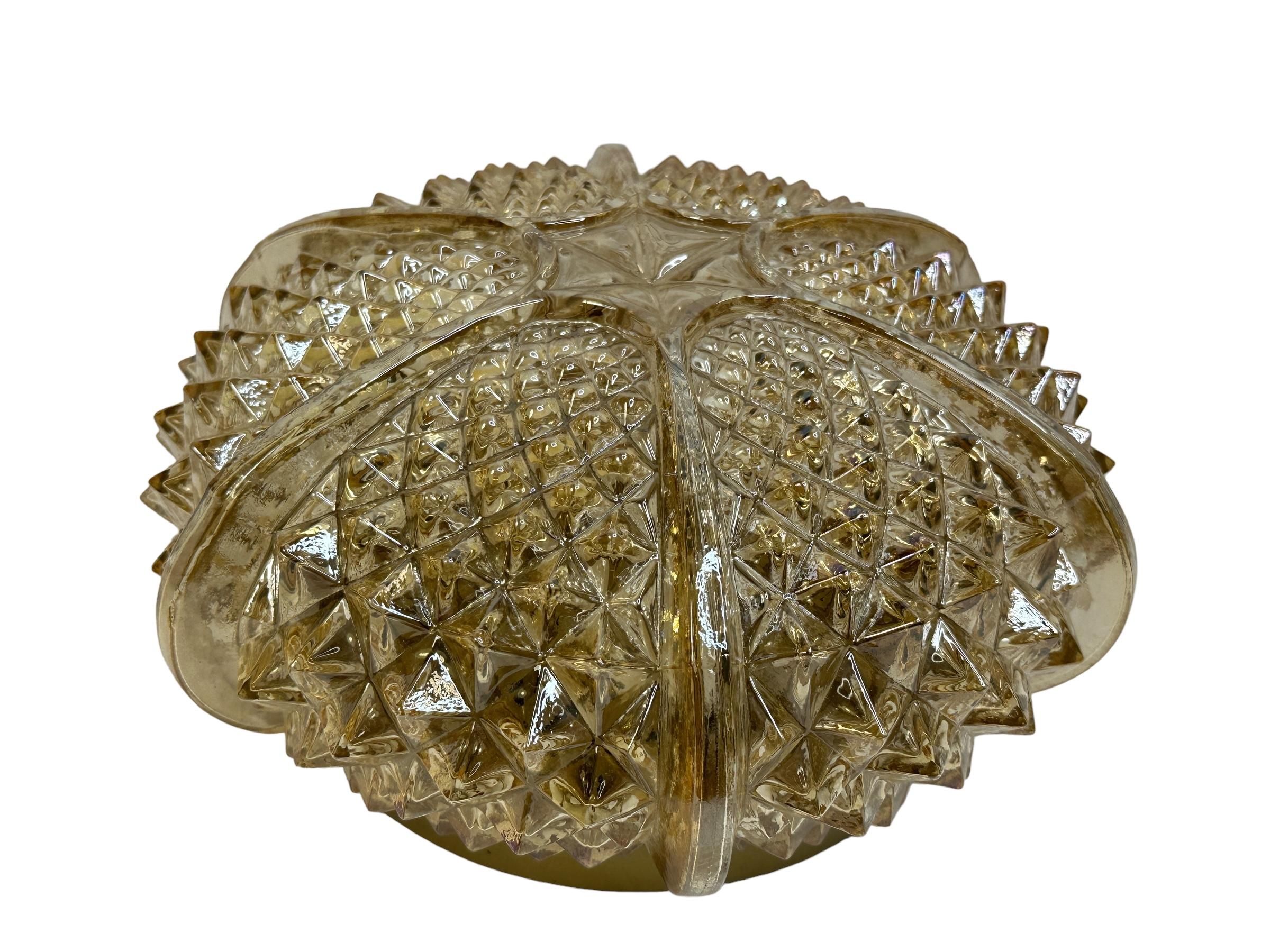 A beautiful German glass flush mount with metal fixture. The fixture requires one European E27 / 110 Volt Edison bulbs, up to 60 watt. It has a smoked or amber colored glass. A nice addition to any room. Found at an Estate Sale in Nuremberg, Germany.