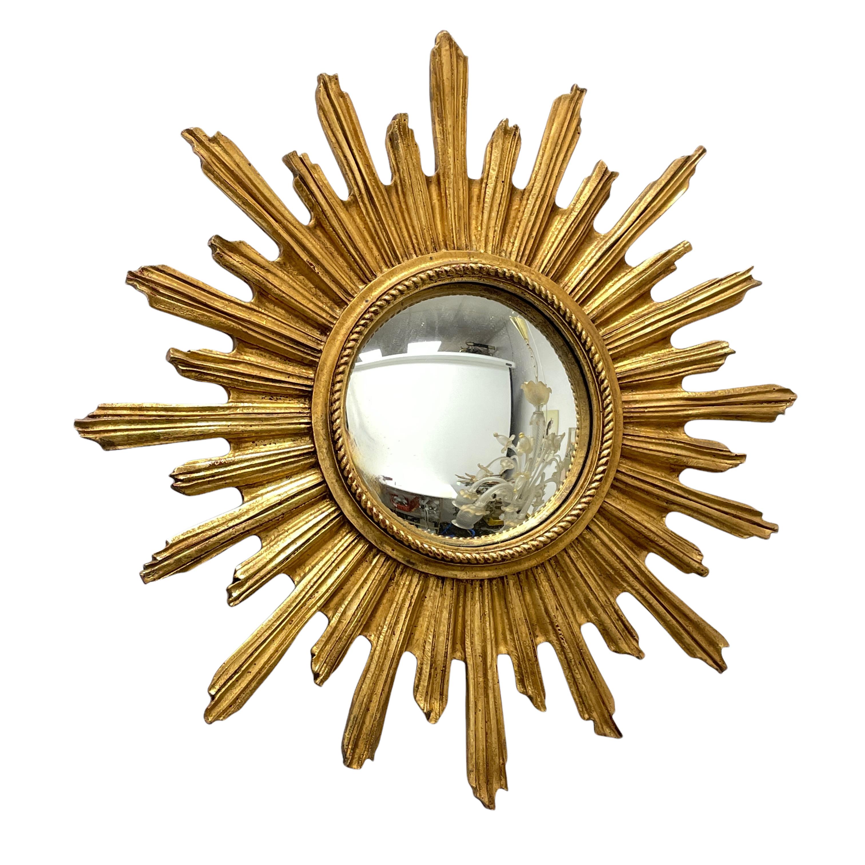 A beautiful starburst sunburst mirror. Made of gilded resin and wood. It measures approximate 20 7/8