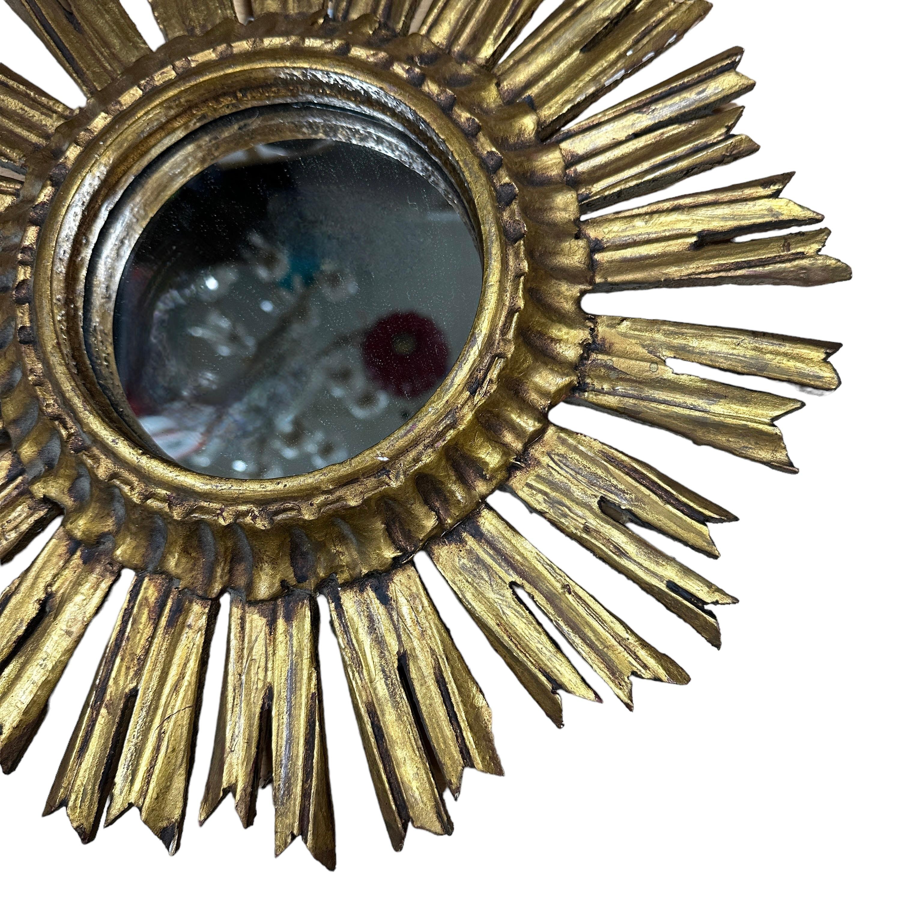A beautiful starburst sunburst mirror. Made of gilded wood. It measures approximate 15.75