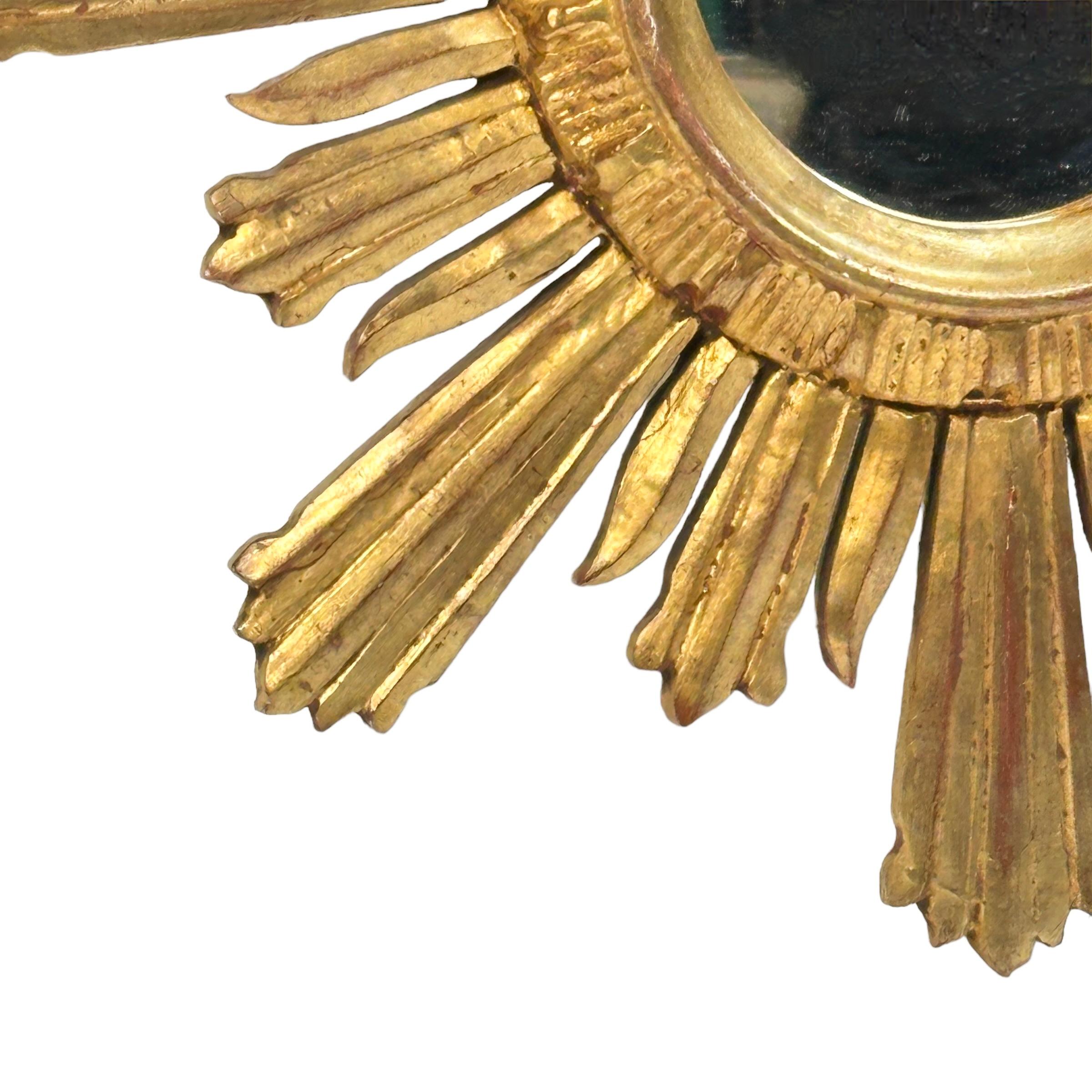 A beautiful starburst sunburst mirror. Made of gilded wood. It measures approximate 18.63