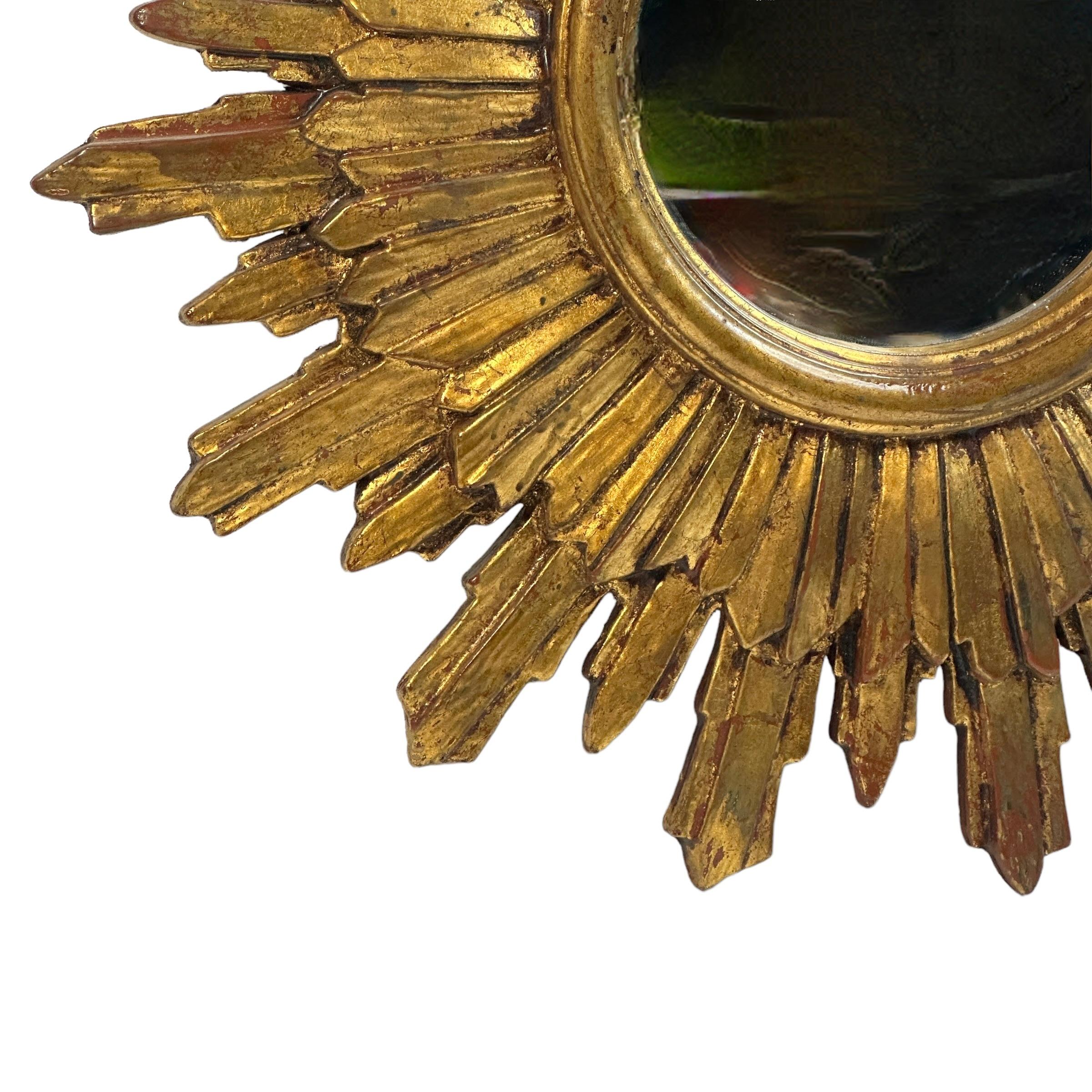 A beautiful starburst sunburst mirror. Made of gilded wood. It measures approximate 21.25