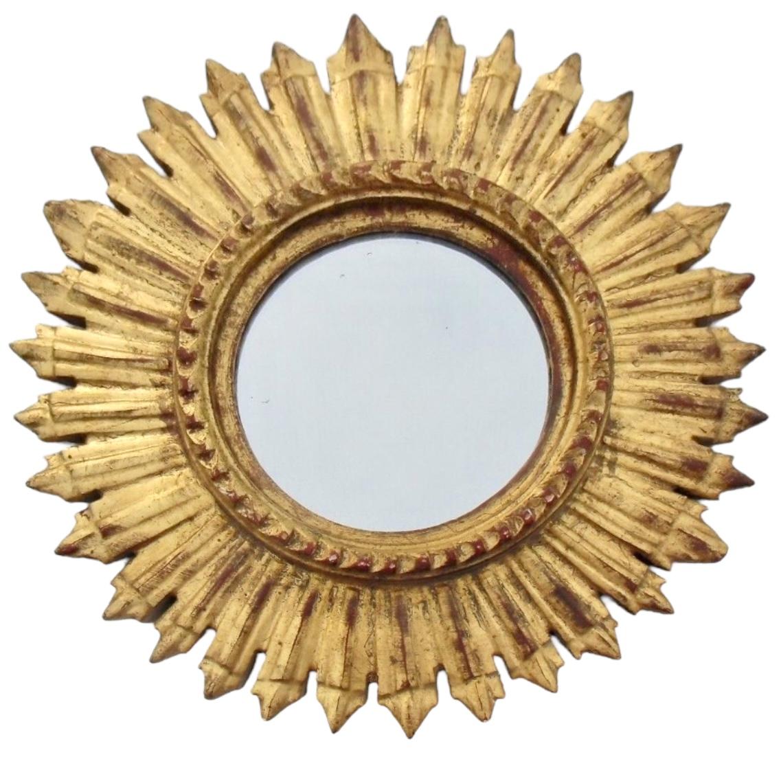 A beautiful starburst sunburst mirror. Made of gilded wood. It measures approximate 12