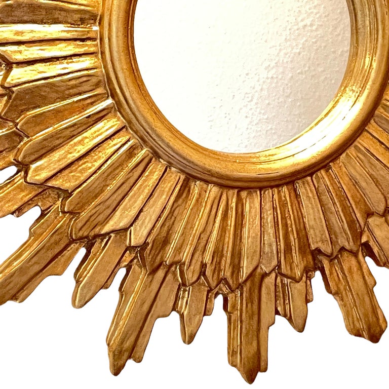 A beautiful starburst sunburst mirror. Made of gilded composition and wood. It measures approximate 20.5