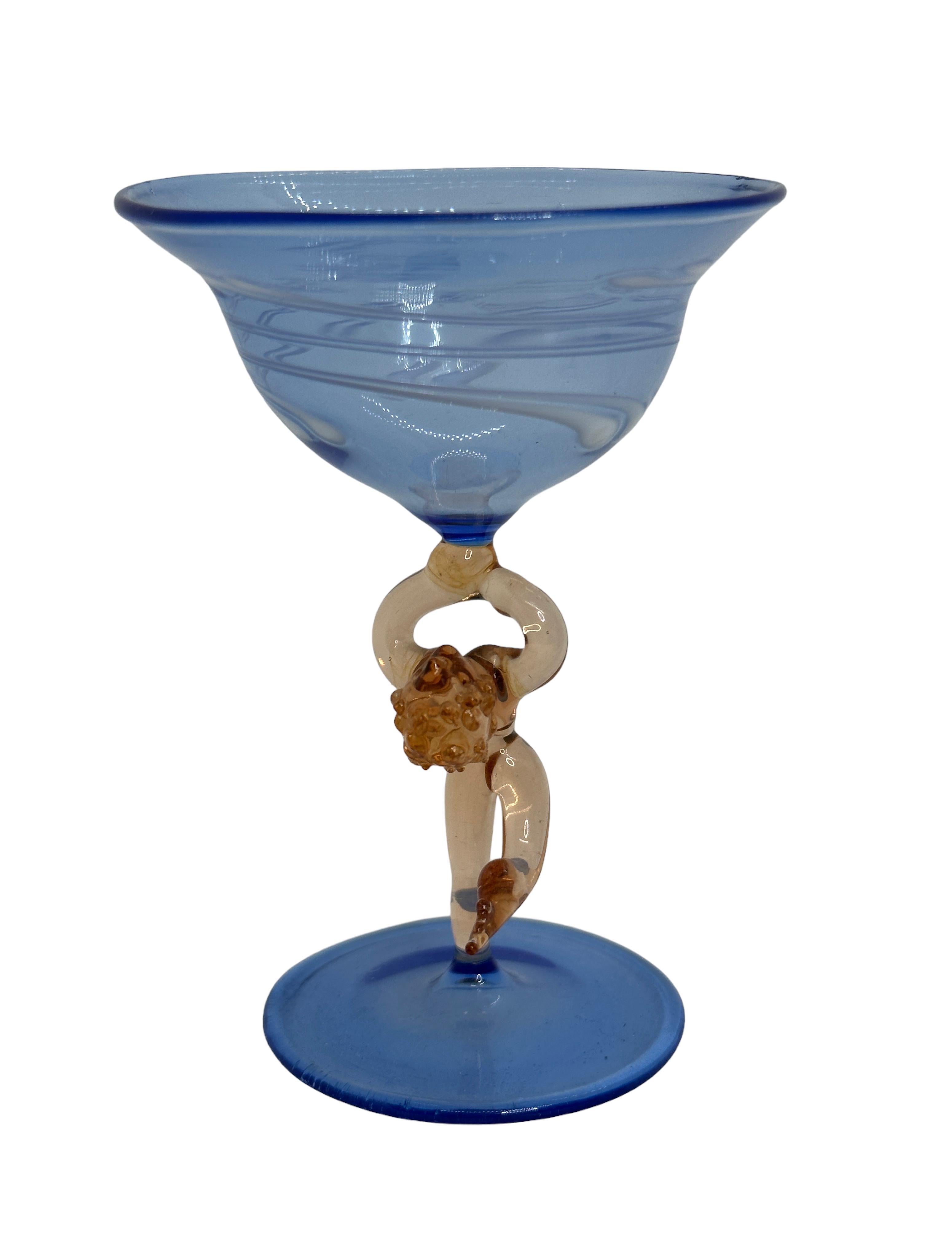 This is a beautiful single vintage stemmed cocktail glass from Austria. It features a bare women's shaft and is in Bimini art style. The blue glass has an embossed design, the stem is a naked lady in pinkish color. The base is a beautiful blue