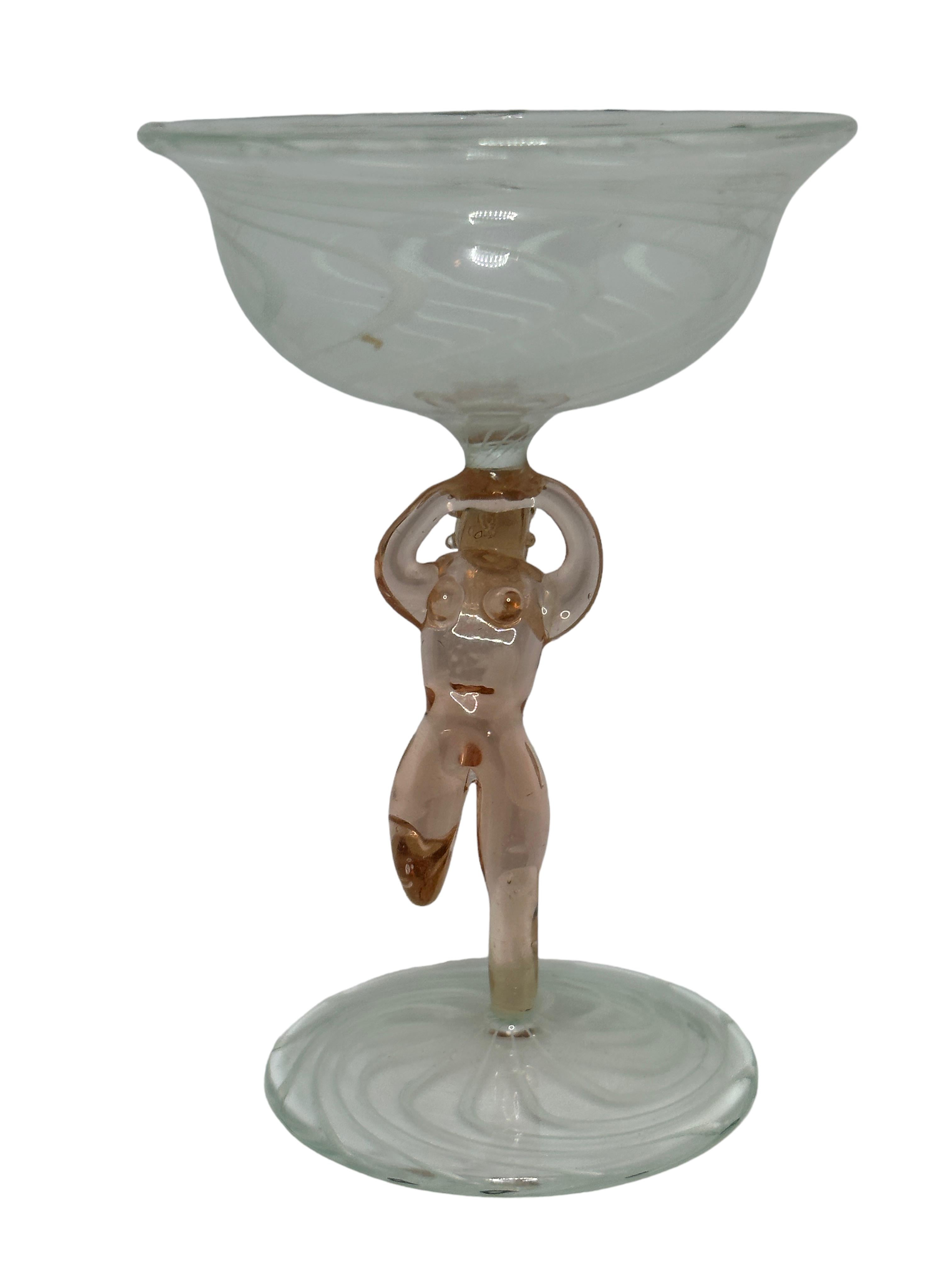 This is a beautiful single vintage stemmed cocktail glass from Austria. It features a bare women's shaft and is bimini art style. The clear glass has a wonderful swirl design, the stem depicts a nude lady in pink colour. The base is a beautiful