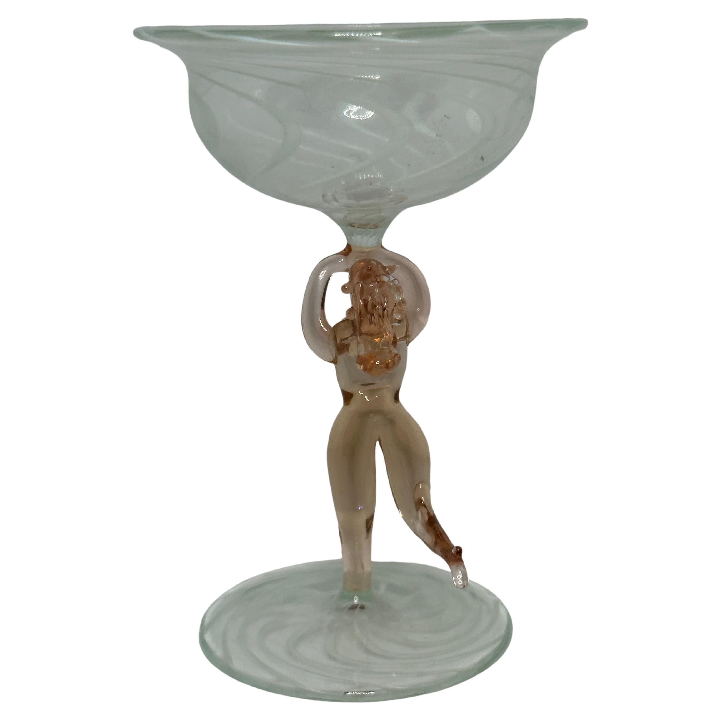 This is a beautiful single vintage stemmed cocktail glass from Austria. It features a bare women's shaft and is bimini art style. The clear glass has a wonderful swirl design, the stem depicts a nude lady in pink colour. The base is a beautiful