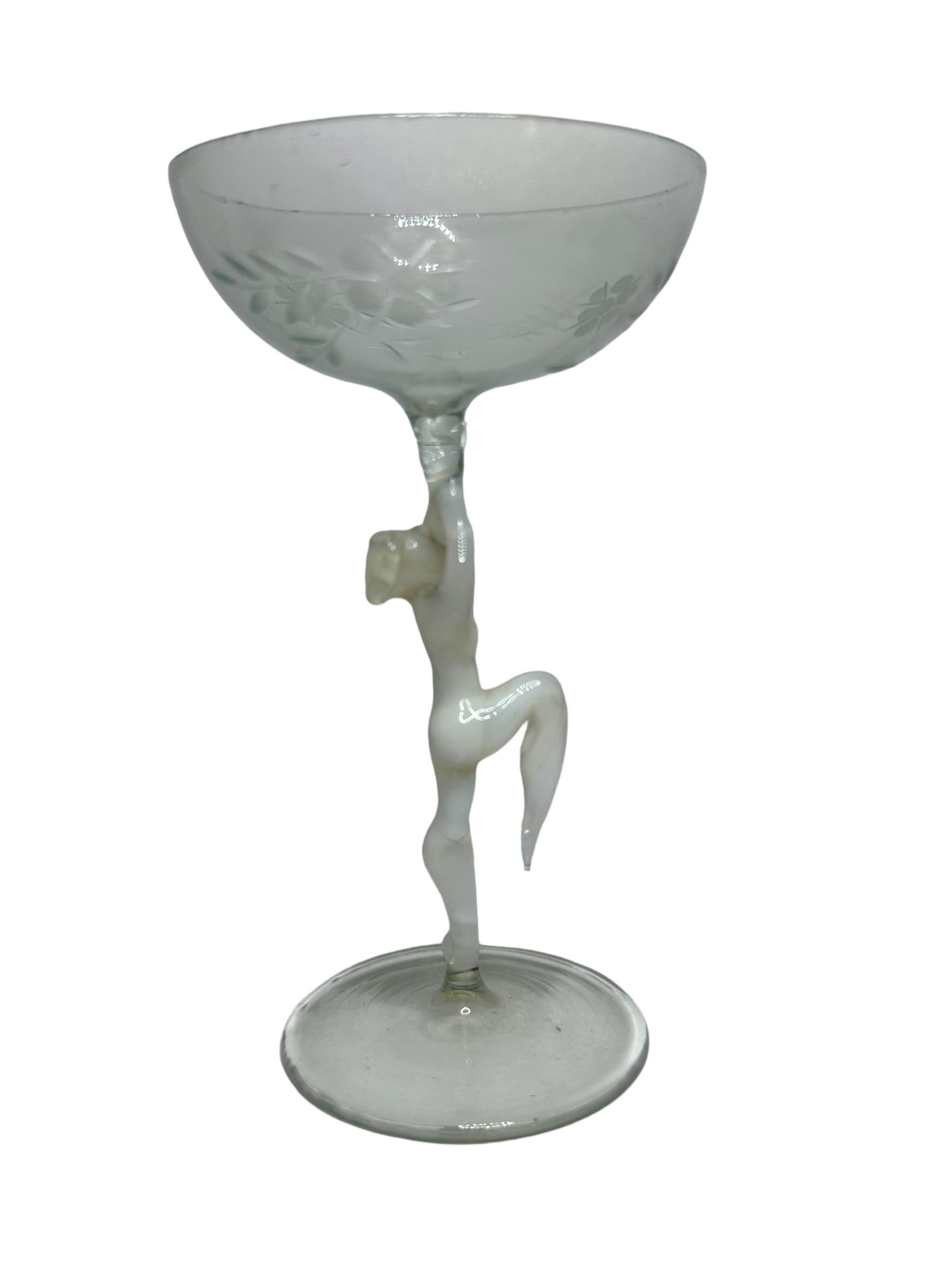 This is a beautiful single vintage stemmed liqueur glass from Austria. It features a bare women's shaft and is Bimini art style. The glass has a wonderful design, the stem depicts a nude lady in white color. The base and the top is a beautiful clear