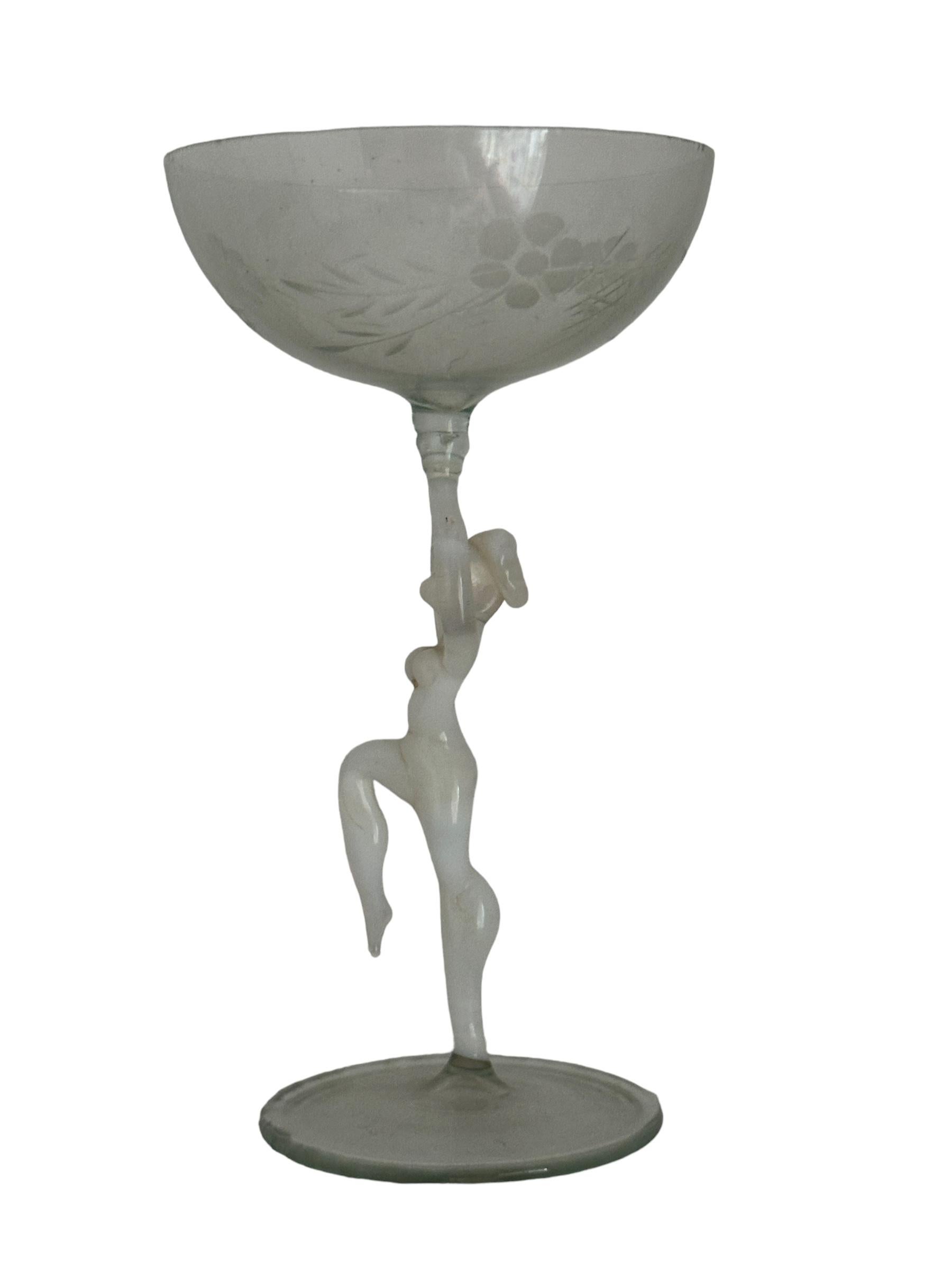 This is a beautiful single vintage stemmed liqueur glass from Austria. It features a bare women's shaft and is Bimini art style. The glass has a wonderful design, the stem depicts a nude lady in white color. The base and the top is a beautiful clear