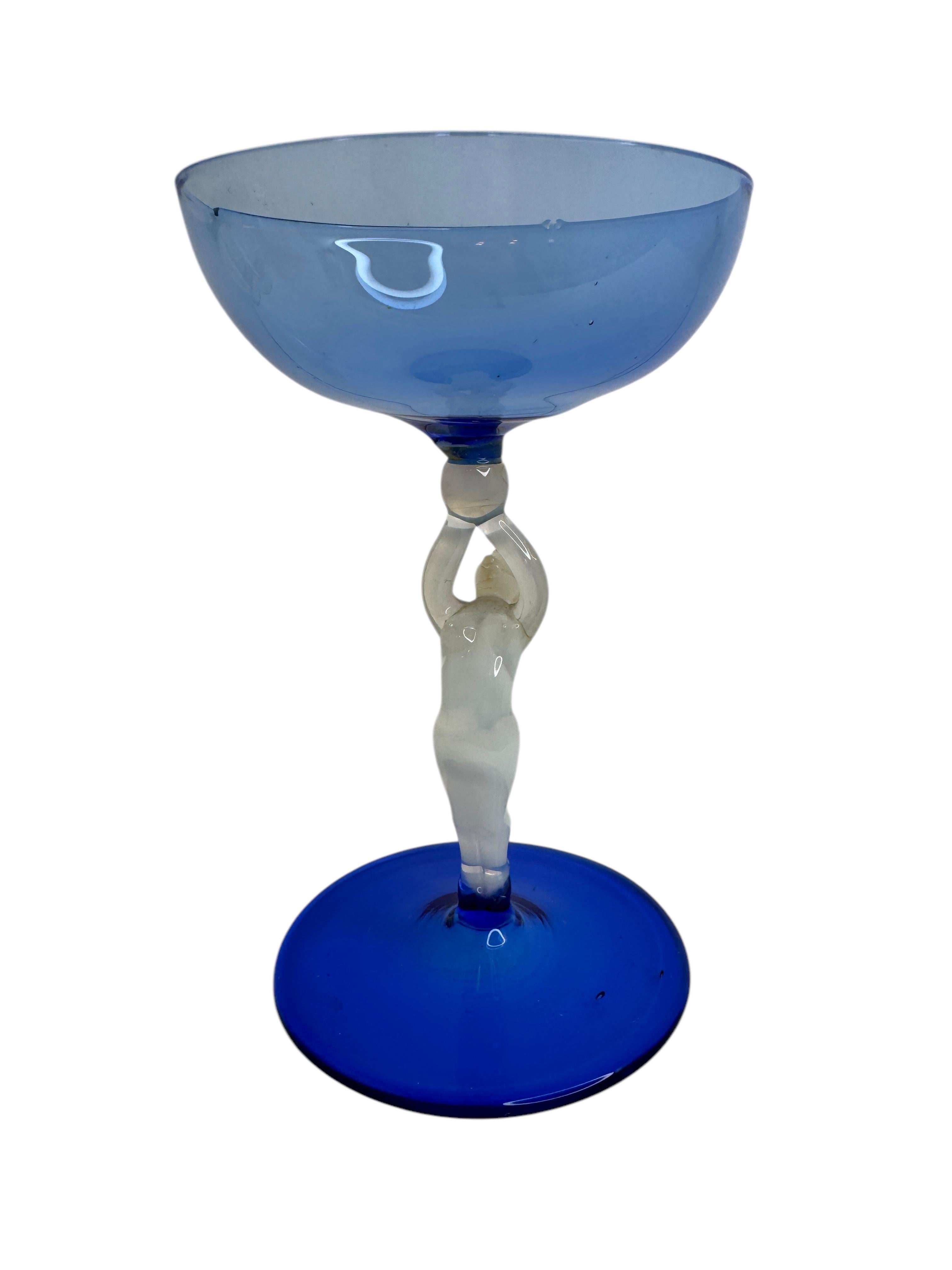 This is a beautiful single vintage stemmed cocktail glass from Austria. It features a bare women's shaft and is in Bimini art style. The blue glass has an embossed design, the stem is a naked lady in white color. The base is a beautiful blue glass.