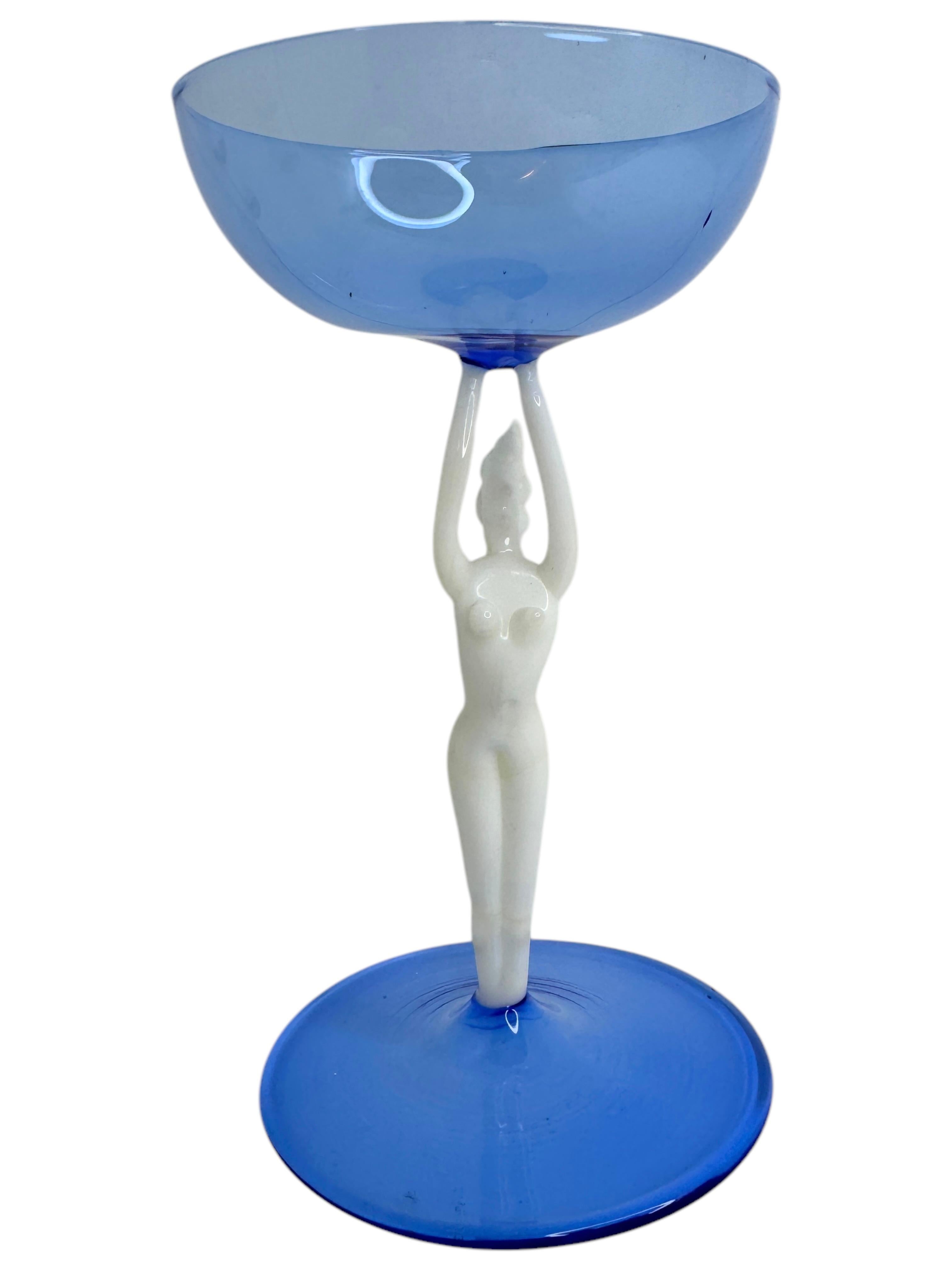 This is a beautiful single vintage stemmed cocktail glass from Austria. It features a bare women's shaft and is in Bimini art style. The blue glass has an embossed design, the stem is a naked lady in white color. The base is a beautiful blue glass.