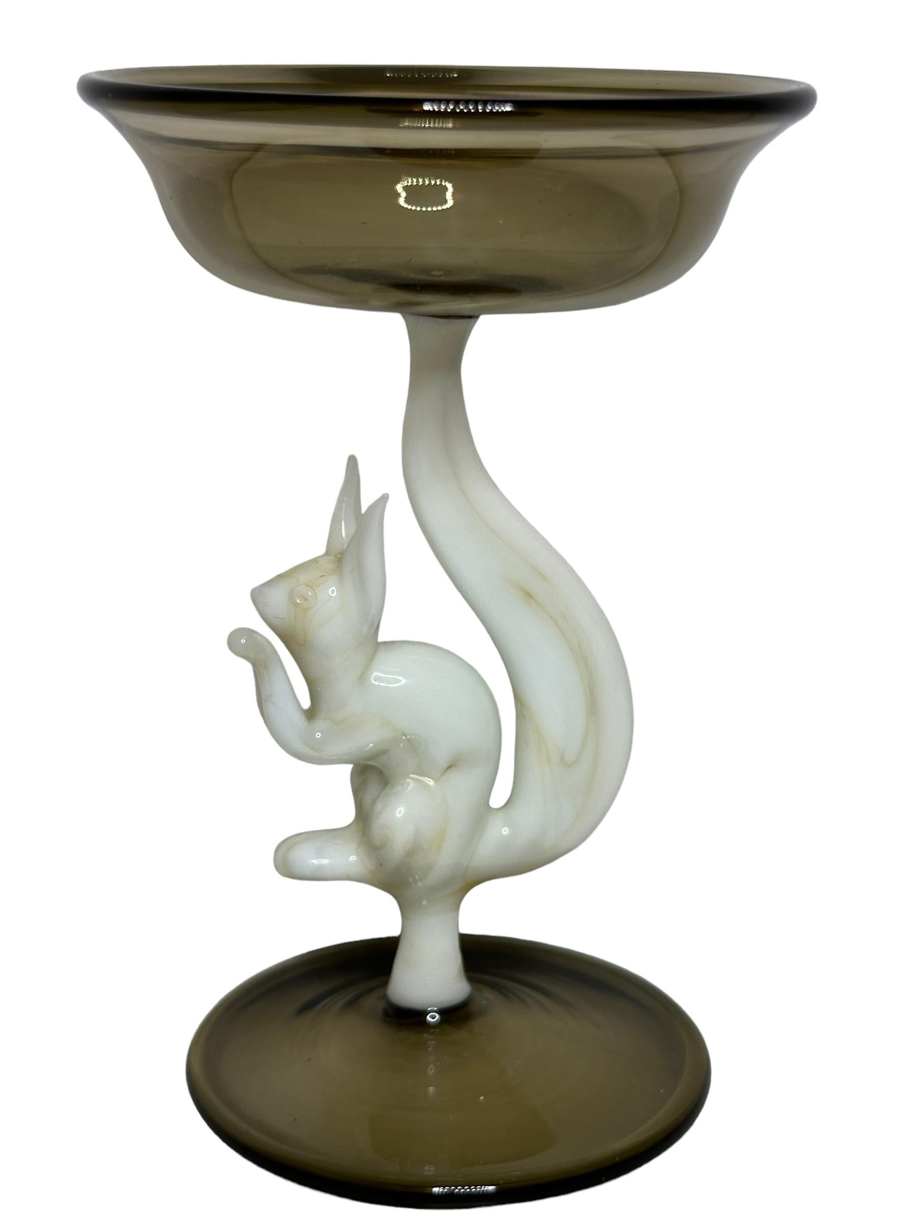 This is a beautiful single vintage stemmed liqueur glass from Austria. It features a animal shaft and is Bimini art style. The glass has a wonderful design, the stem depicts a Squirrel in white color. The base and the top is a beautiful smoked