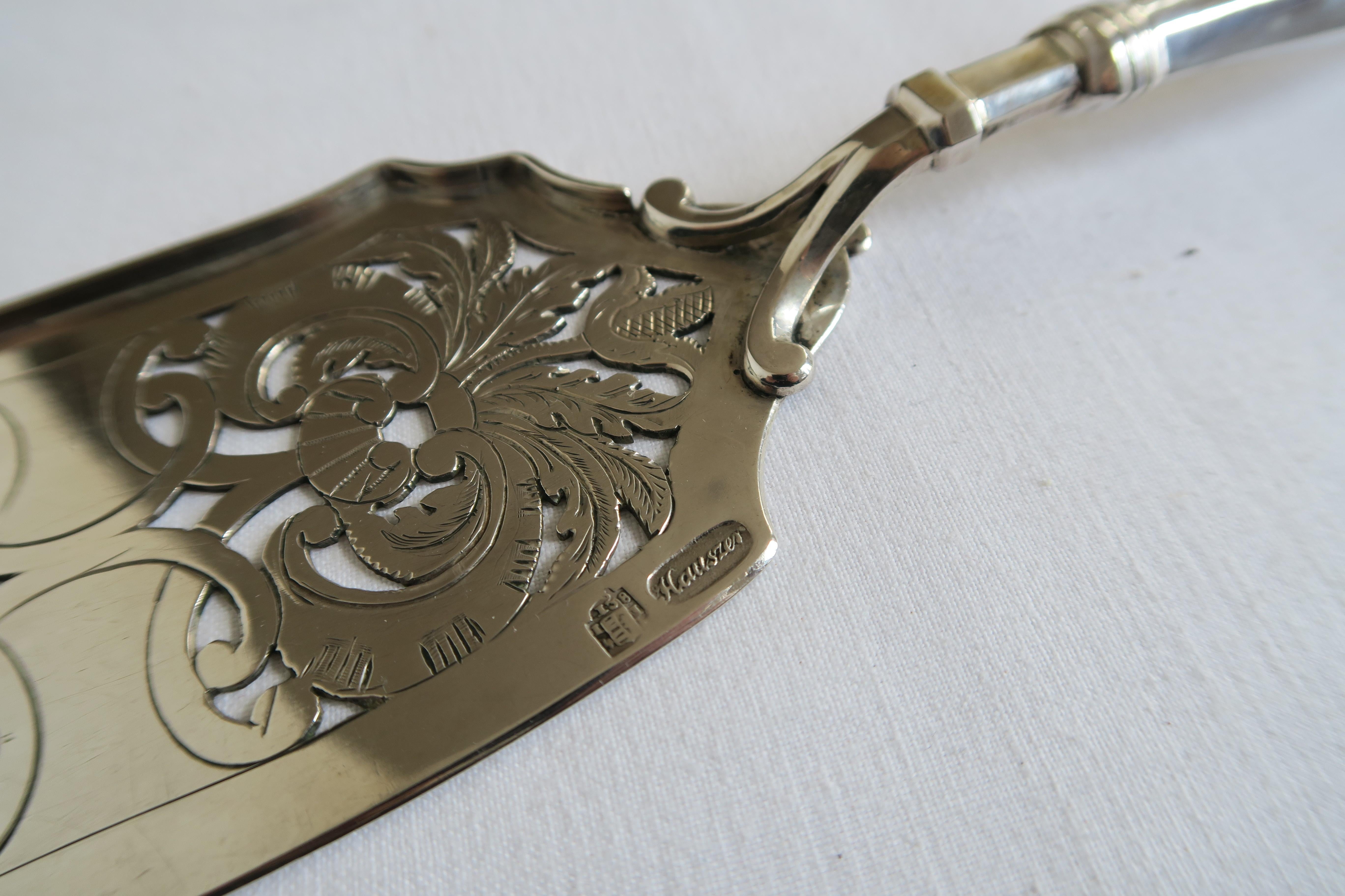 The item for sale is a beautiful, ornamental rococo cake shovel or fish server. It was made in 1841 according to the hallmark and owned by the K+K Monarchy of Austria. It was handcrafted from solid sterling silver with the most intricate ornaments