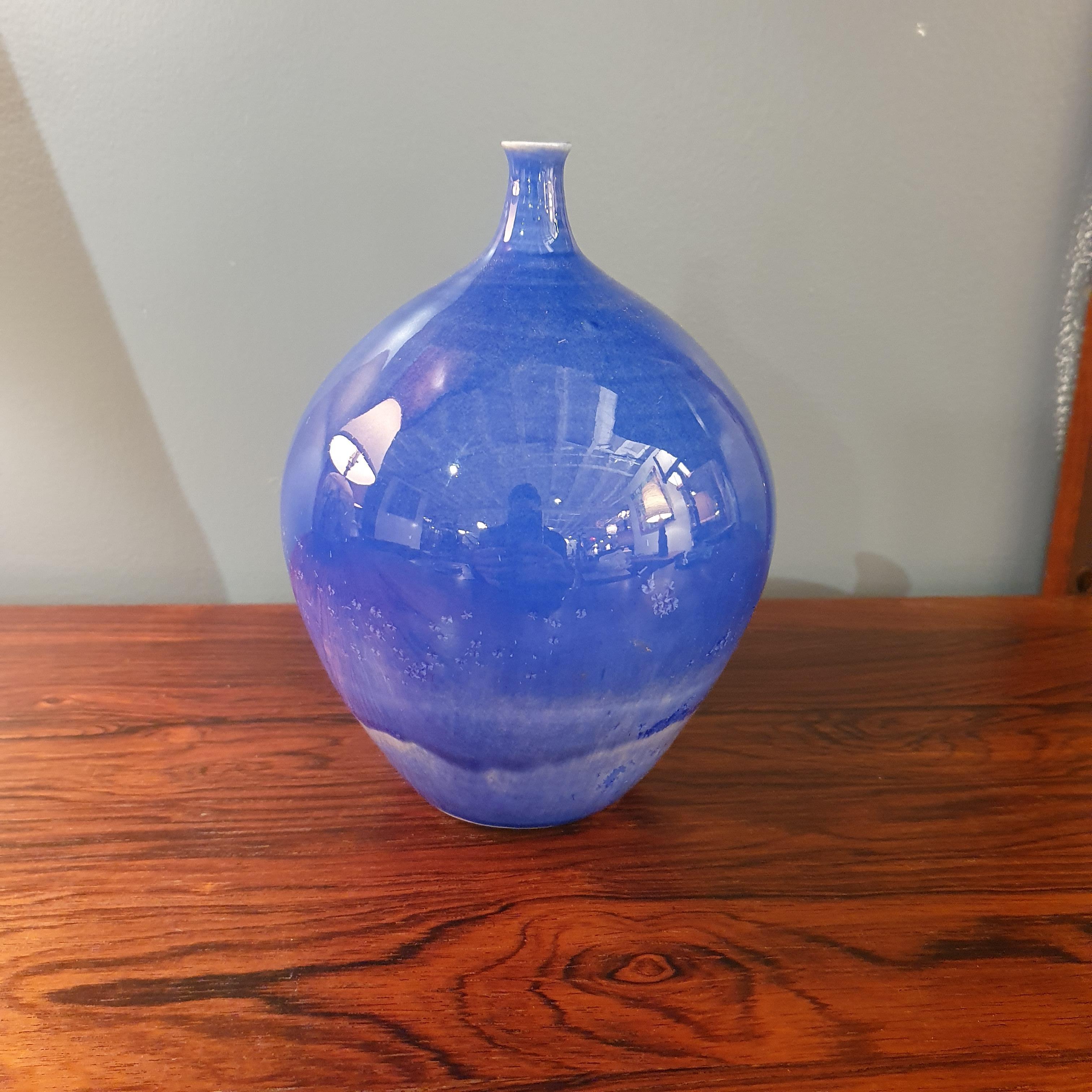 Beautiful blue glazed ceramic studio pottery bud vase. Measures 4.5 round and 6.5 tall. Signed by artist on underside 