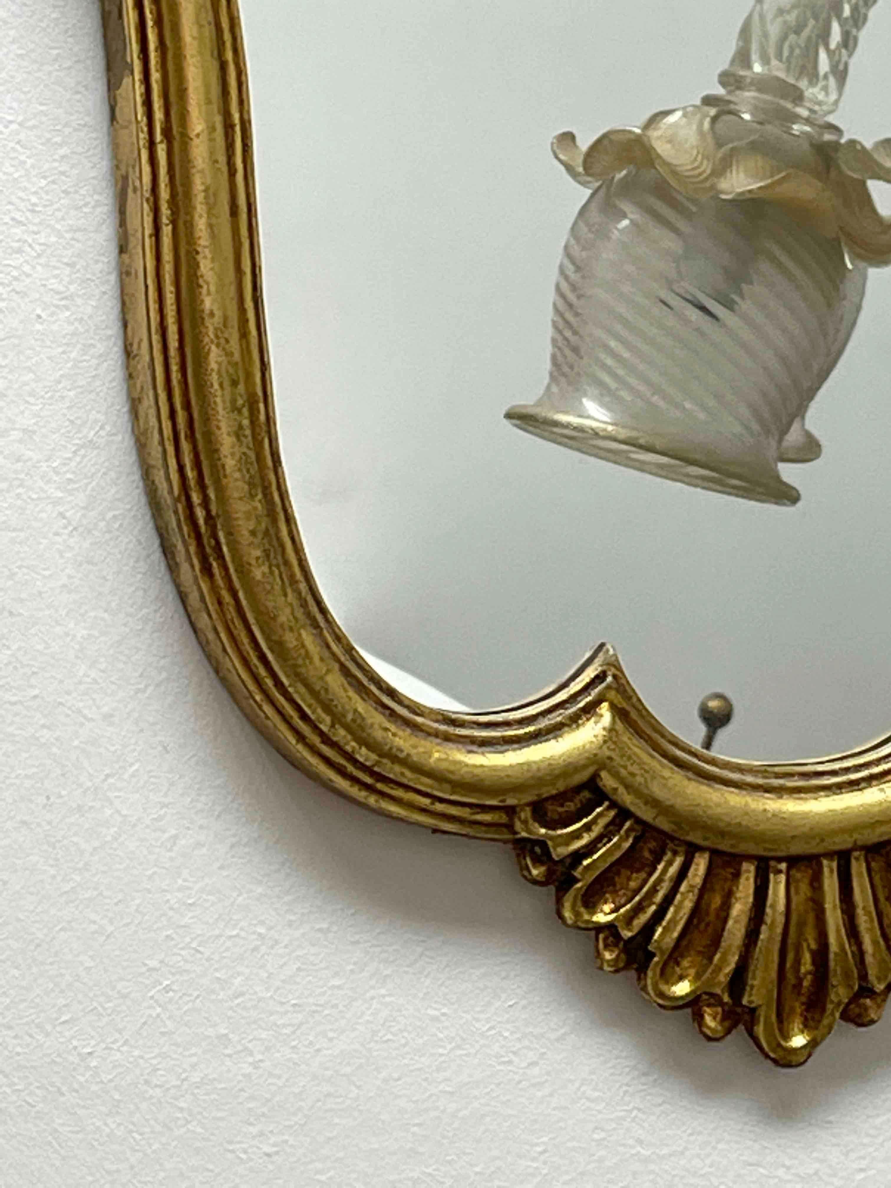Stunning toleware mirror. The gilded frame surrounds a glass mirror. Made in Italy, circa 1950s. Beautiful mirror for any room or your hall entry. Nice addition to any room.
