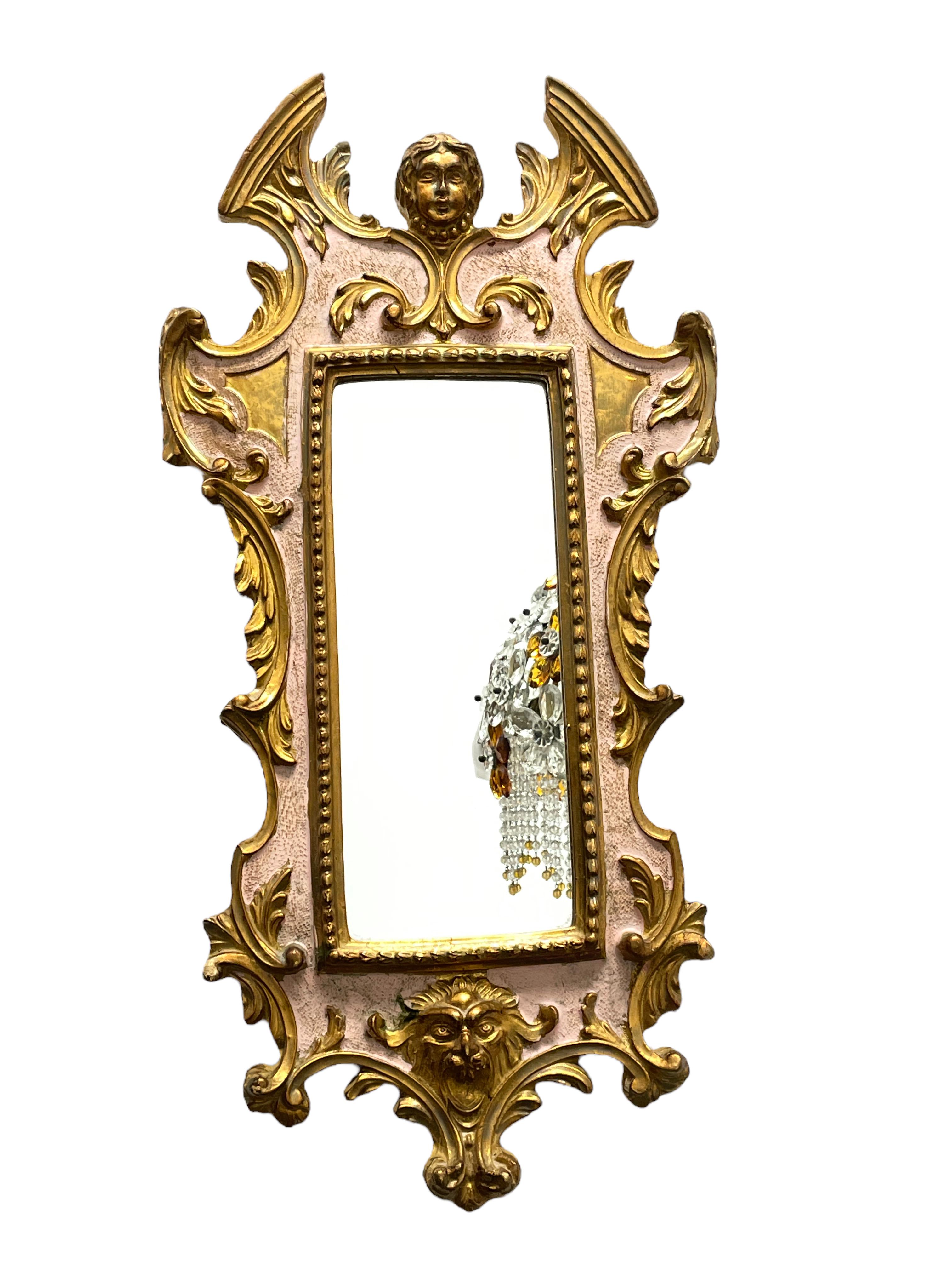 A stunning early 20th C. Italian mirror with lovely old paint & gilding.
The ornate frame features a wonderful winged angel finial and lion face mask to the base. 
Minor cosmetic wear to the frame, the mirrored plate is clean & has been replaced