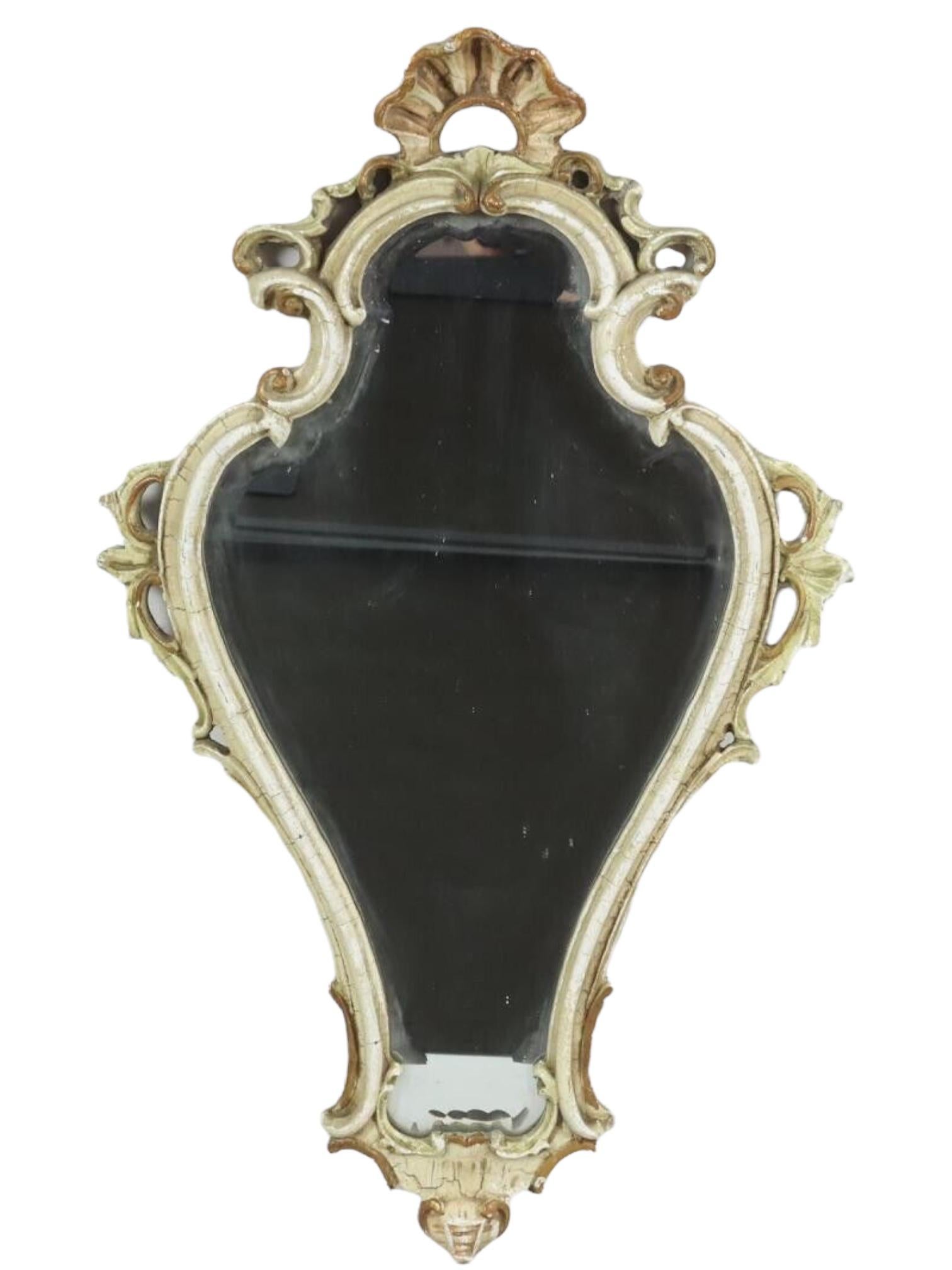 Stunning toleware mirror. The gilded and white frame surrounds a glass mirror. Made in Germany, circa 19th Century. Frame has craquelure and slight loss of paint in places, but this is old-age. 
Beautiful mirror for any room or your hall entry.