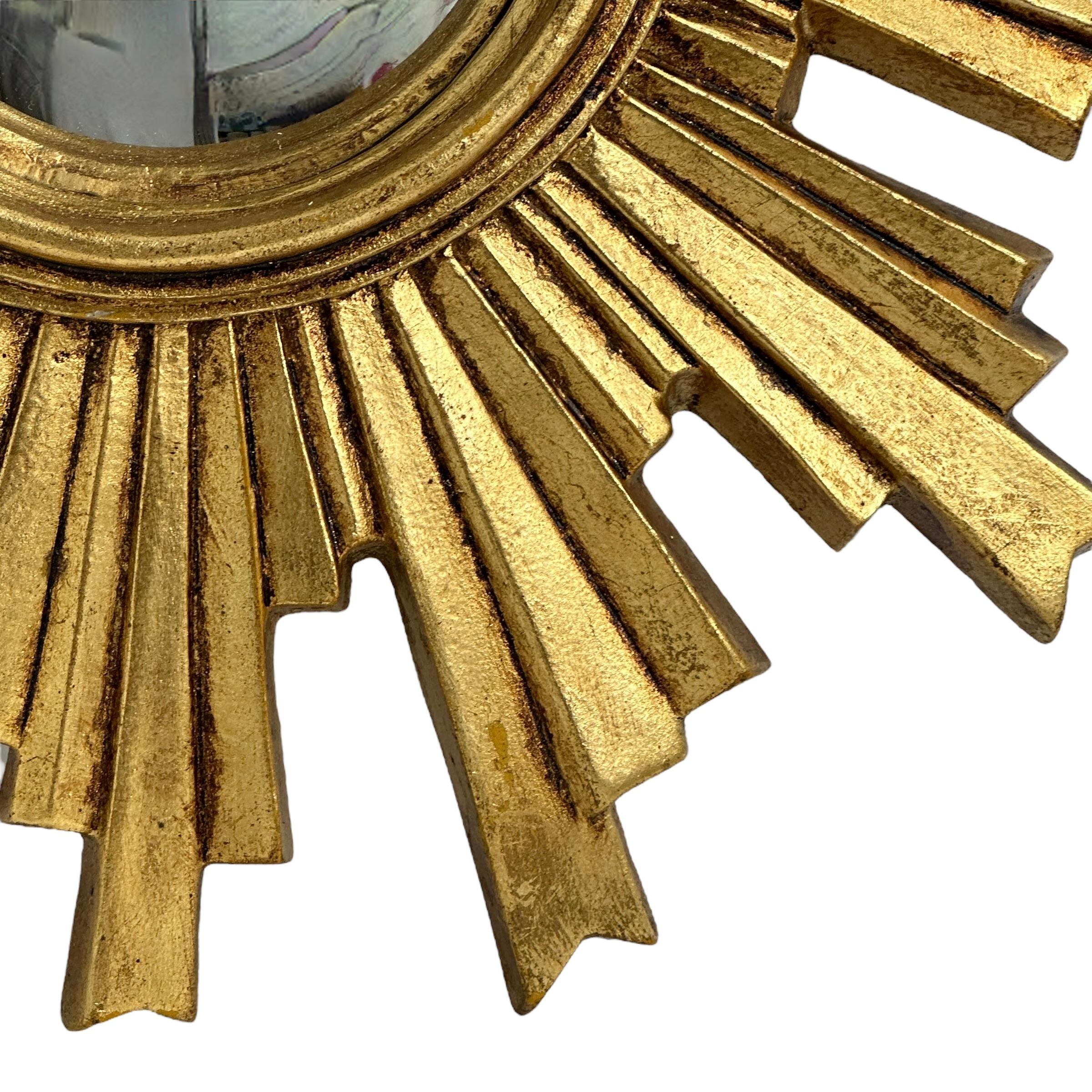 A cute sunburst or starburst mirror. Made of gilded composition or resin. It measures approximate: 14 1/4