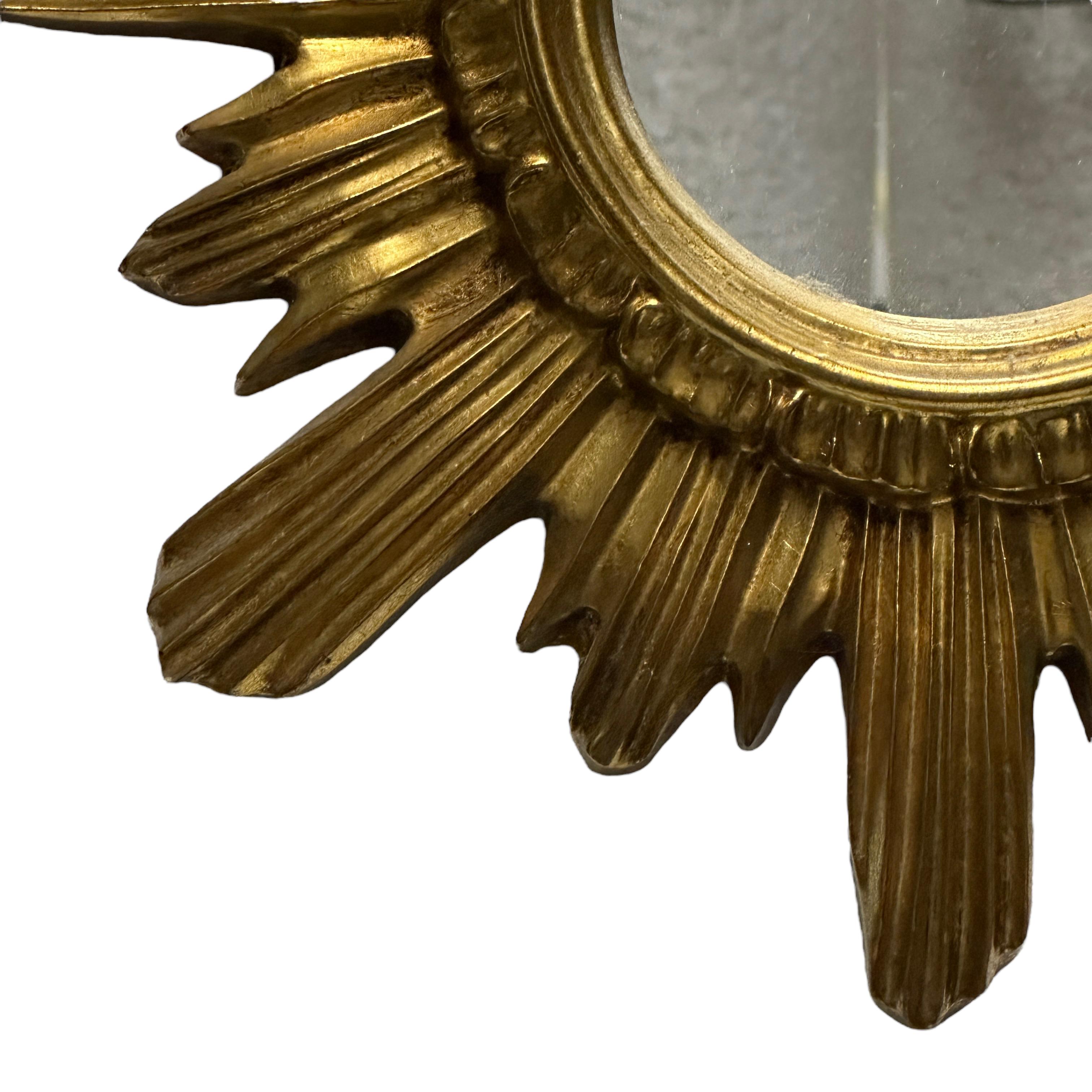 A gorgeous starburst mirror. Made of gilded wood and stucco. No chips, no cracks, no repairs. It measures 16.5