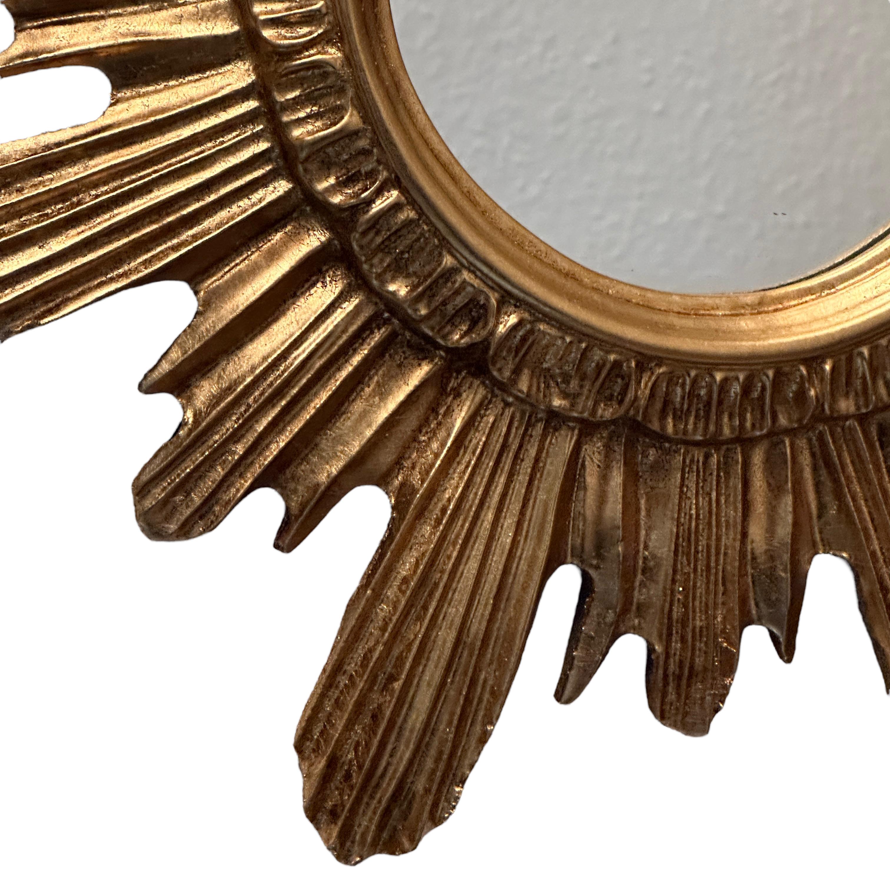 A gorgeous starburst mirror. Made of gilded wood and stucco. No chips, no cracks, no repairs. It measures approximate: 16.63