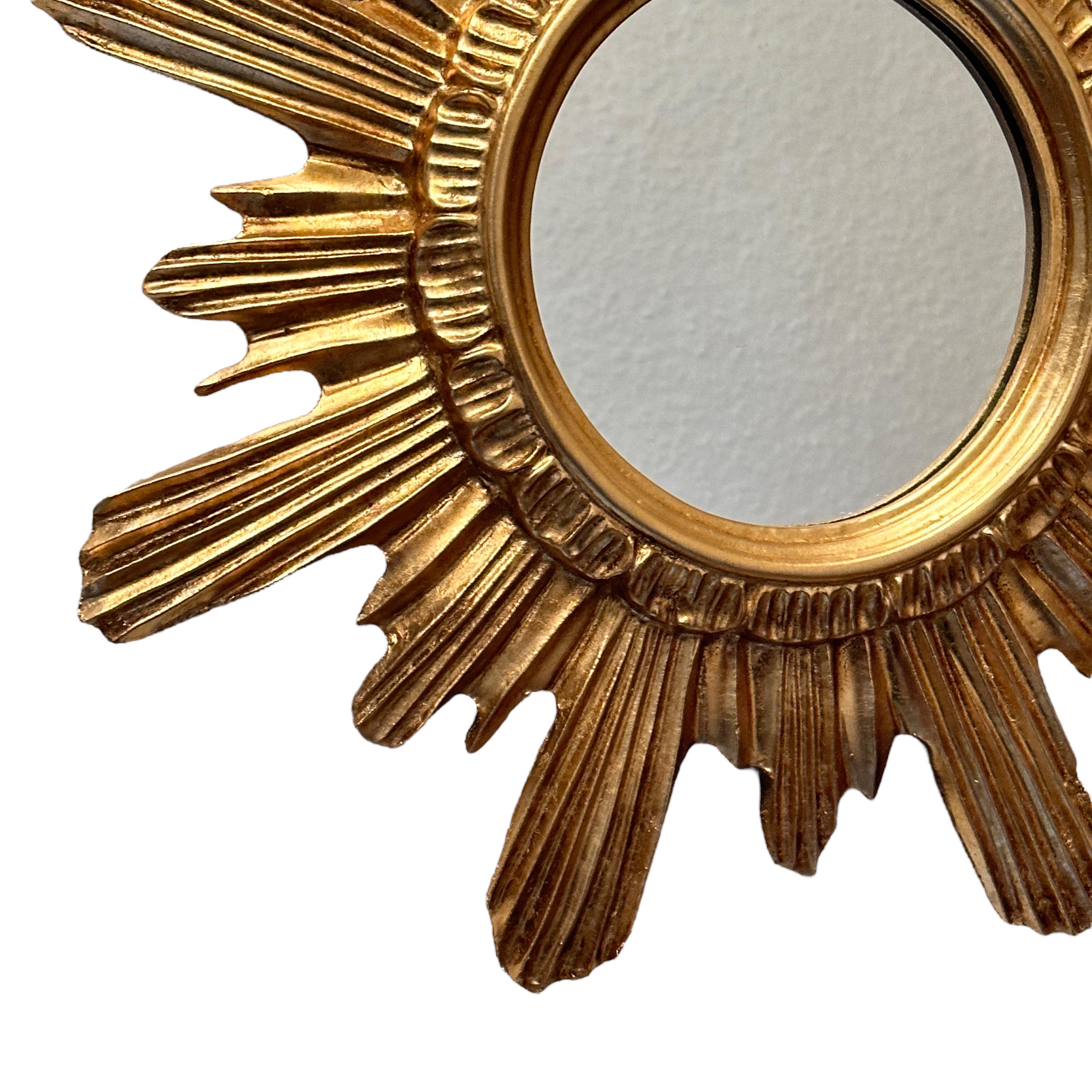 A gorgeous starburst mirror. Made of gilded wood and stucco. No chips, no cracks, no repairs. It measures approximate: 16.63