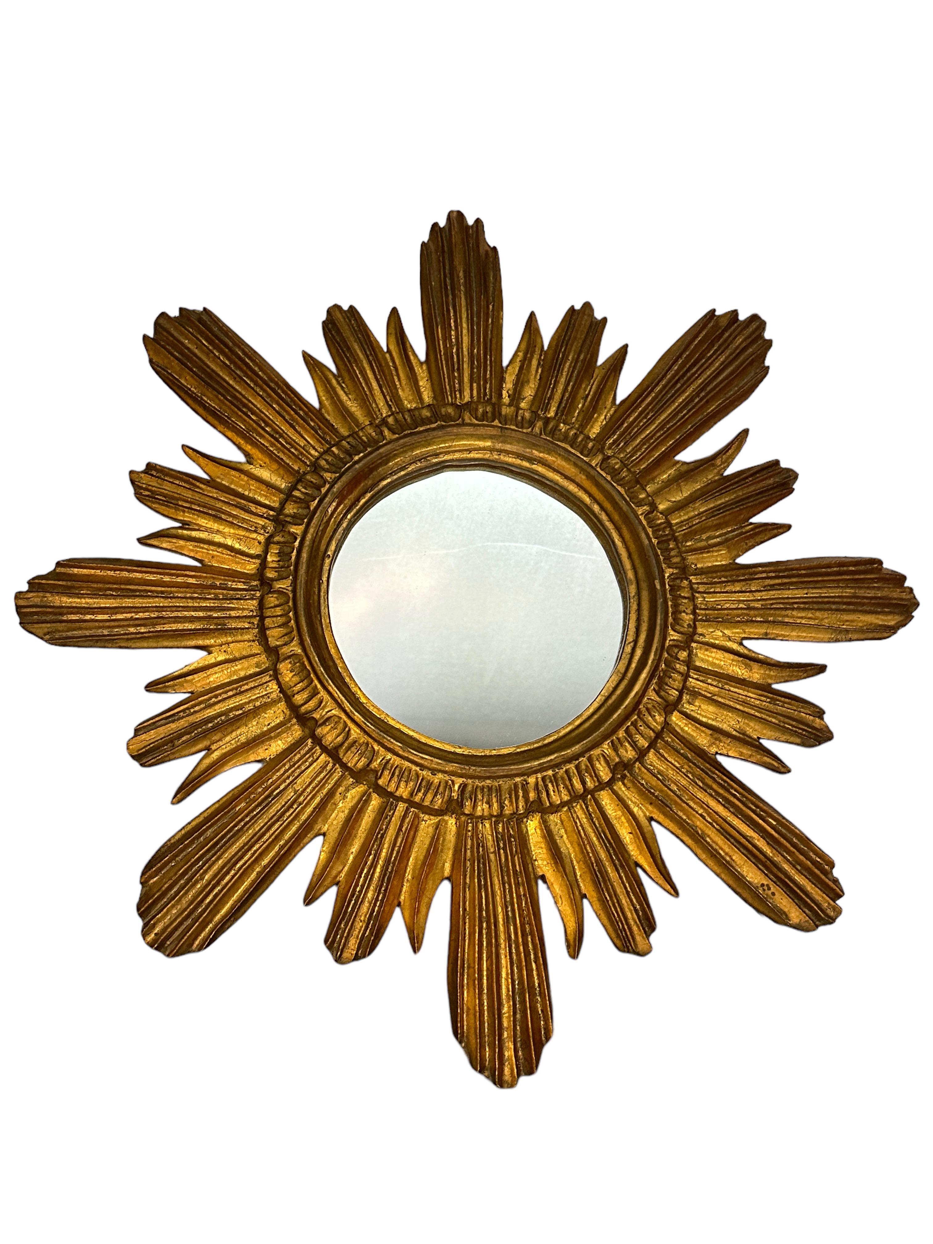 A gorgeous starburst mirror. Made of gilded wood and stucco. No chips, no cracks, no repairs. It measures approximate: 17.38