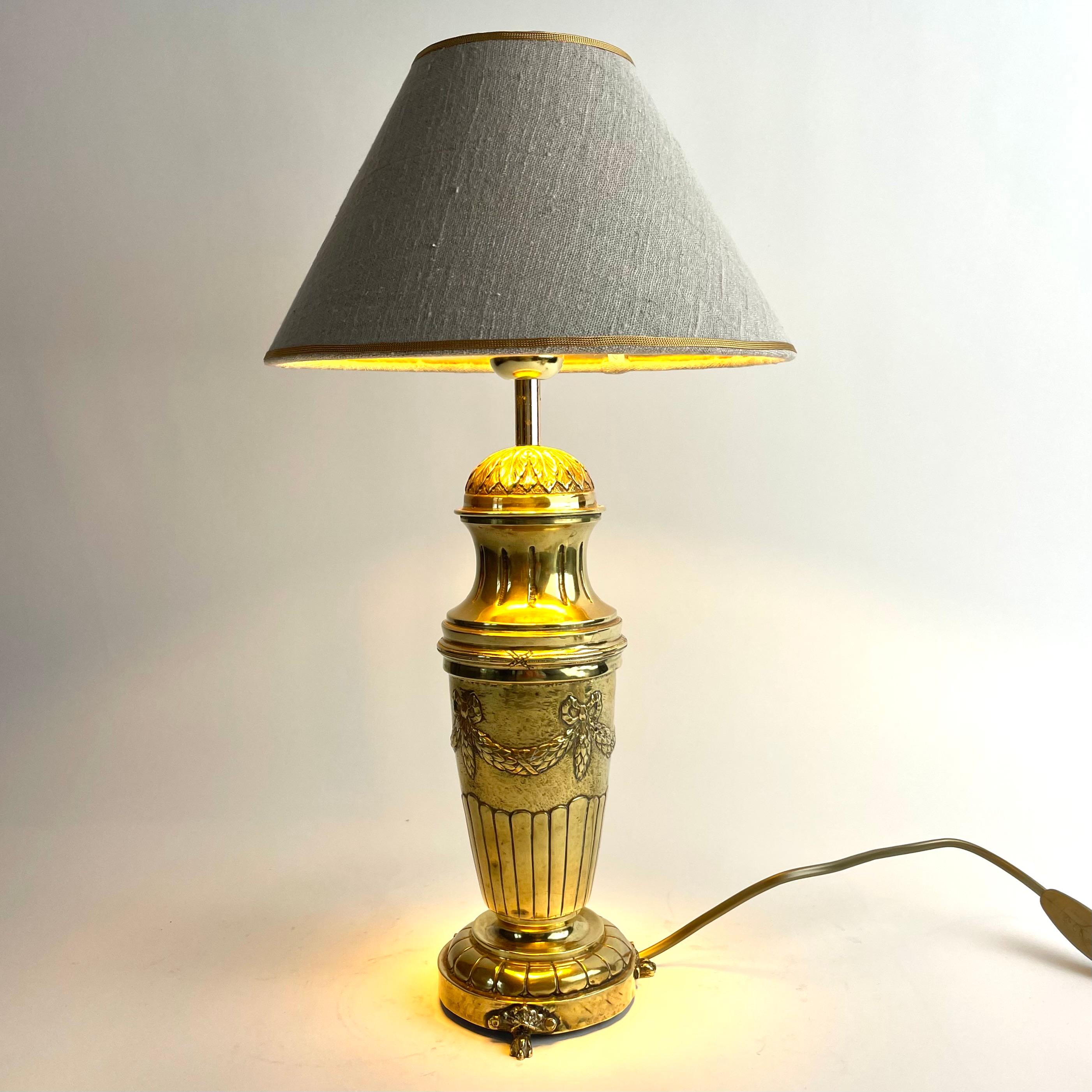 
Beautiful Swedish Gustavian Style Brass Table Lamp, Late 19th Century

A beautiful Gustavian style brass table lamp, most likely from the late 1800s, richly decorated with classical Gustavian elements such as ribbon swags, leaf motifs, and fluted