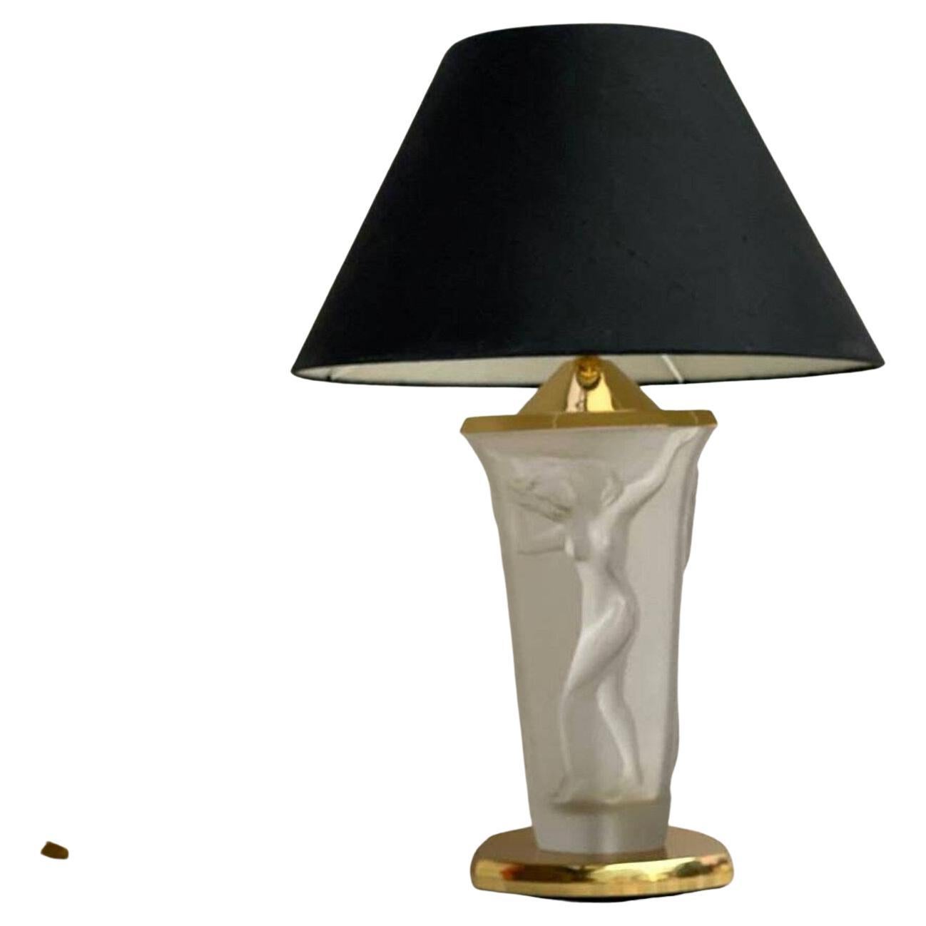 Beautiful brass table lamp with three embossed graces on the opaque art glass. Vintage. 

The lamp has a stylish body of opaque glass and decorated with figurines of graces forming an elegant composition. 

This ensemble is completed by an