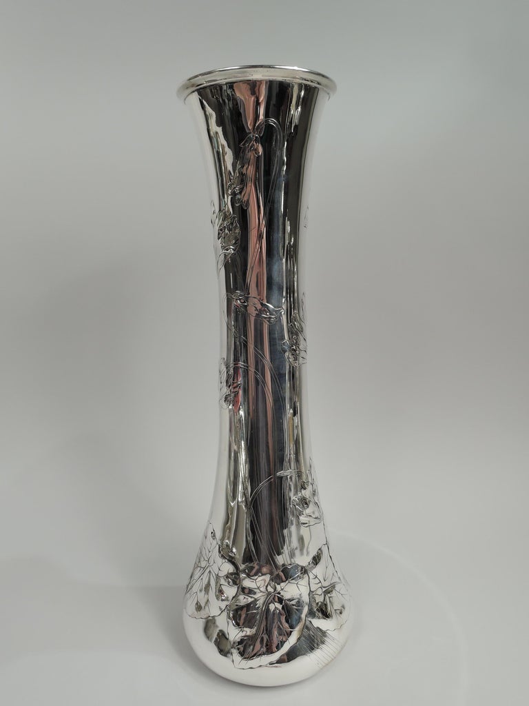 Beautiful turn-of-the-century Art Nouveau sterling silver vase. Made by William B. Durgin in Concord. Conical with tall neck. Chased and engraved entwined tendrils with “shooting” flower heads, and veined and overlapping leaves. Ornament loose and
