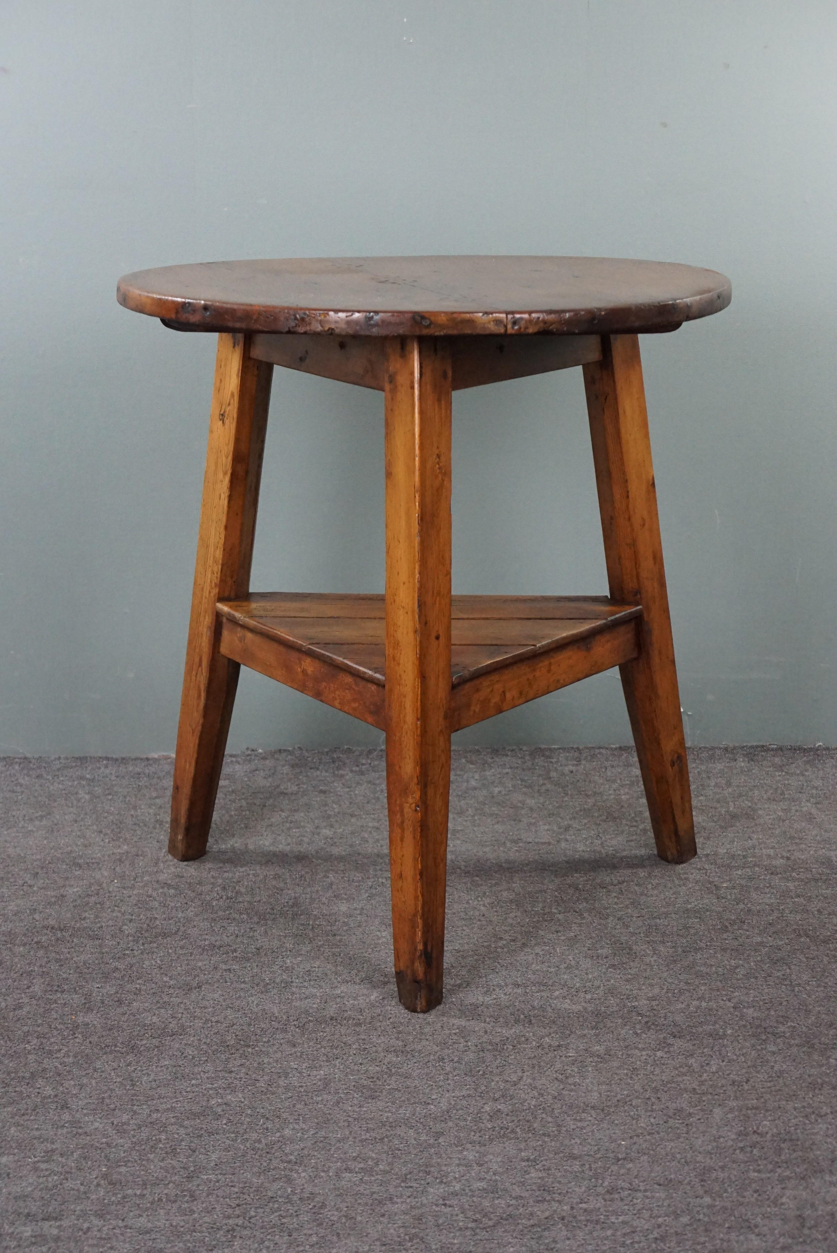 Offered is this beautiful tall, honey-colored, early 19th-century English pinewood cricket table with original nails and oxidation. We ourselves are big fans of cricket tables. Not only for their unique and irresistible appearance but also for their