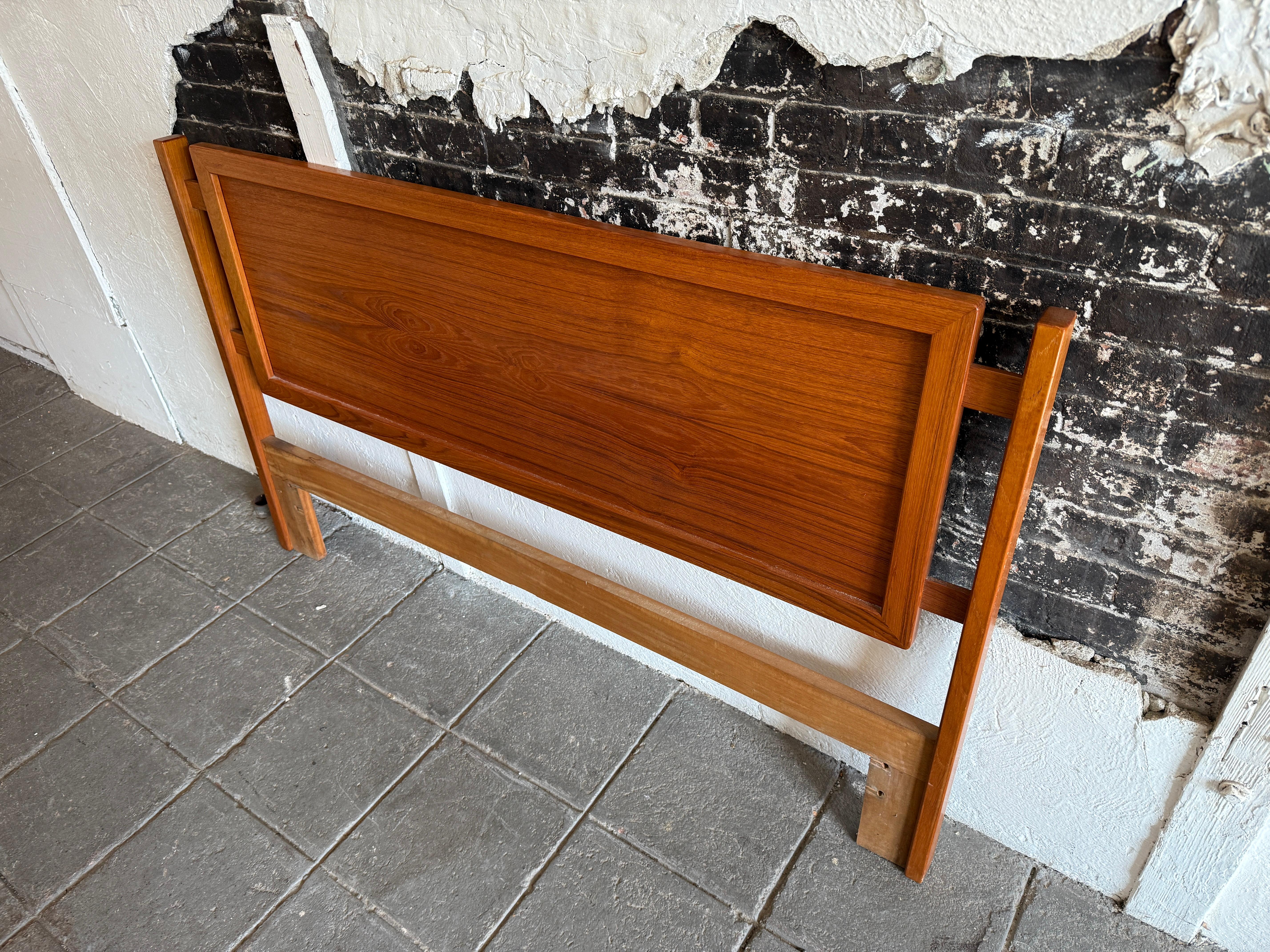 Beautiful teak Danish Mid-Century Modern queen headboard made in Denmark in wonderful condition. Really nice golden brown teak headboard with solid teak wood details. Fits a queen sized mattress. Bed headboard only no metal bed frame. Easily mounts