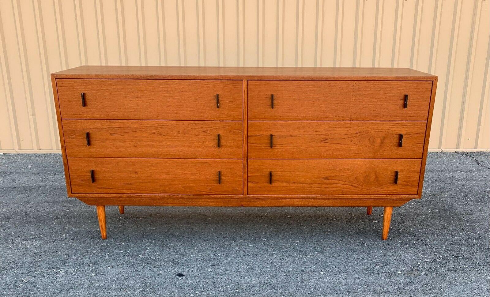 This stunning Danish modern teak dresser features 6 hefty drawers ensuring plenty of room for storage. The clean lines, rich teak finish, and black sleek drawer pulls show quality craftsmanship. This Canadian made midcentury dresser makes the