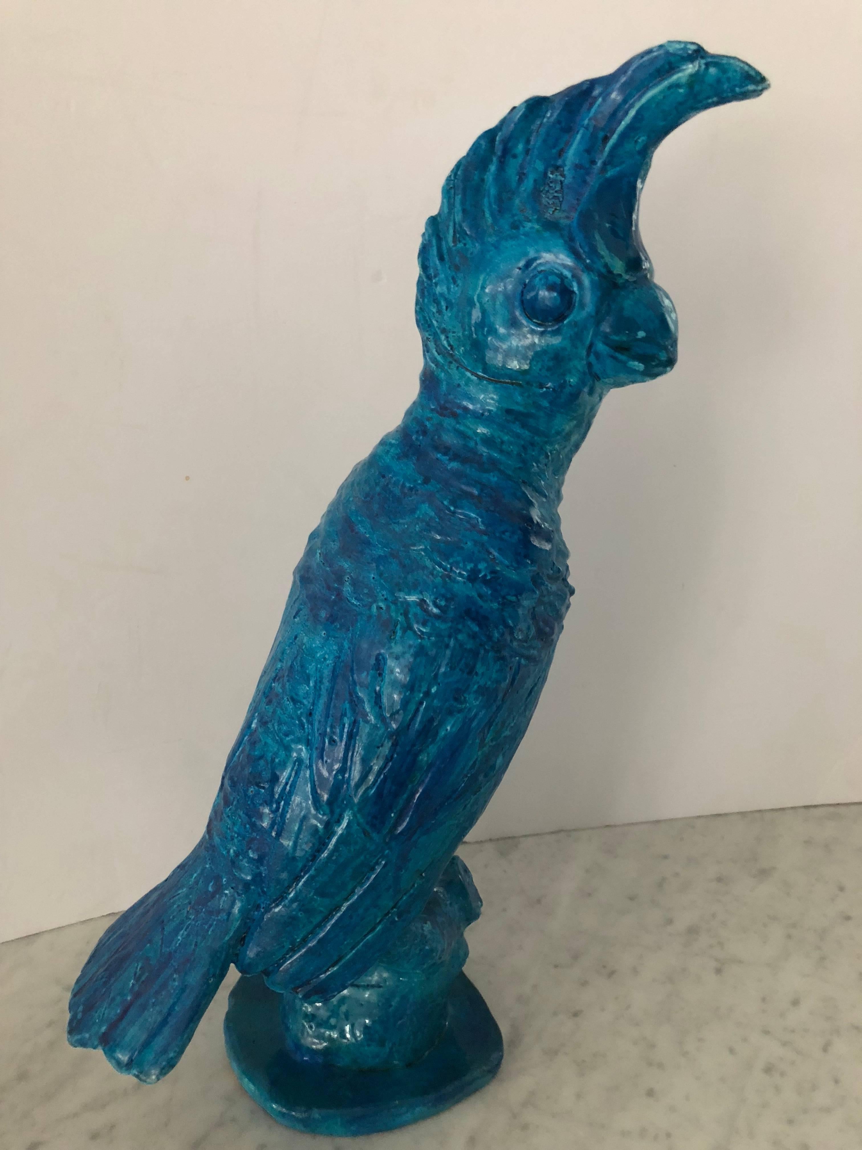 Brilliant turquoise blue parrot sculpture. Beautifully glazed and molded clay; unsigned by artist.