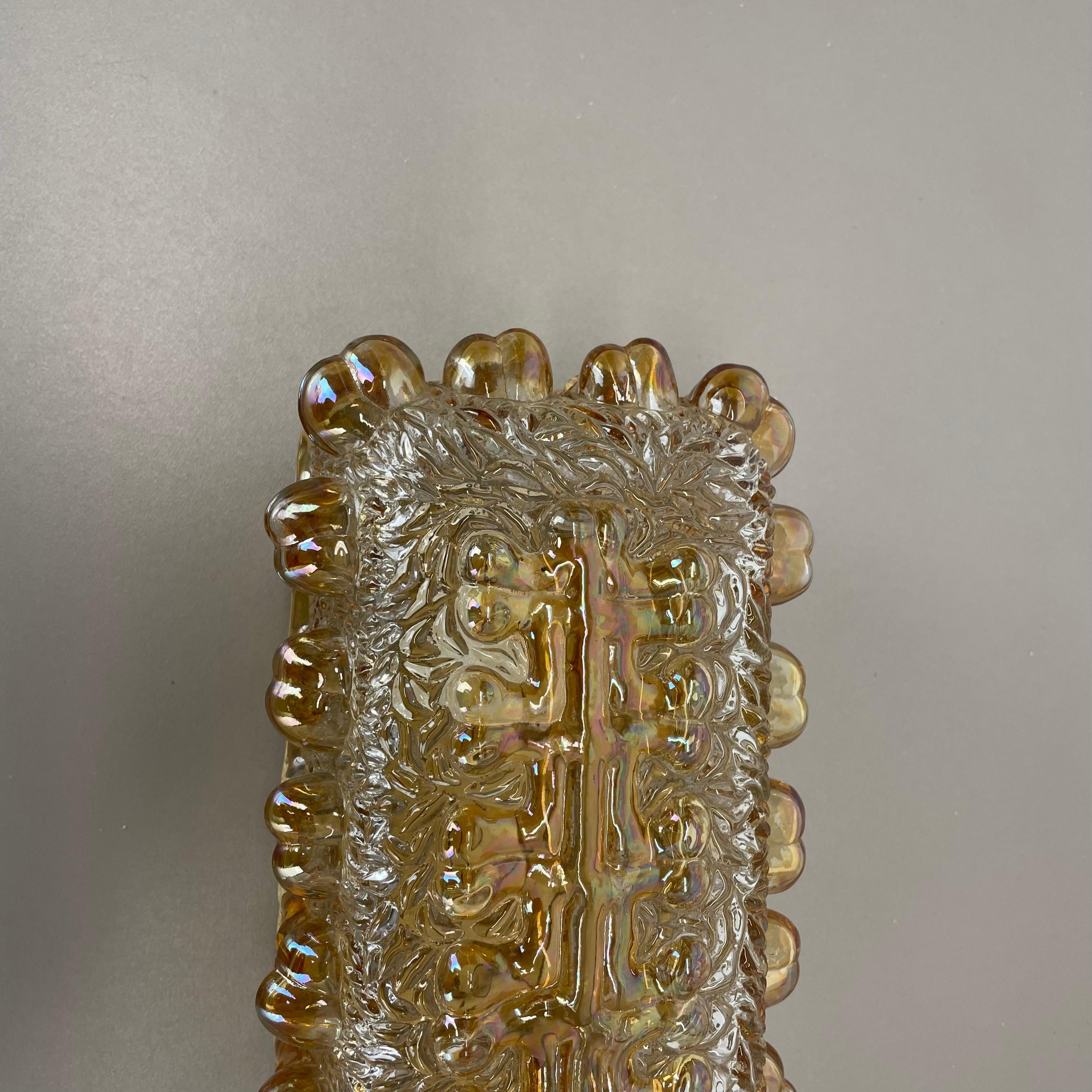 Article:

Wall light sconce


Origin:

Germany



Age:

1970s



This original modernist wall light was produced in Germany in the 1970s. It is made from heavy glass and has a metal wall fixation. The light havs a fantastic abstract and Brutalist