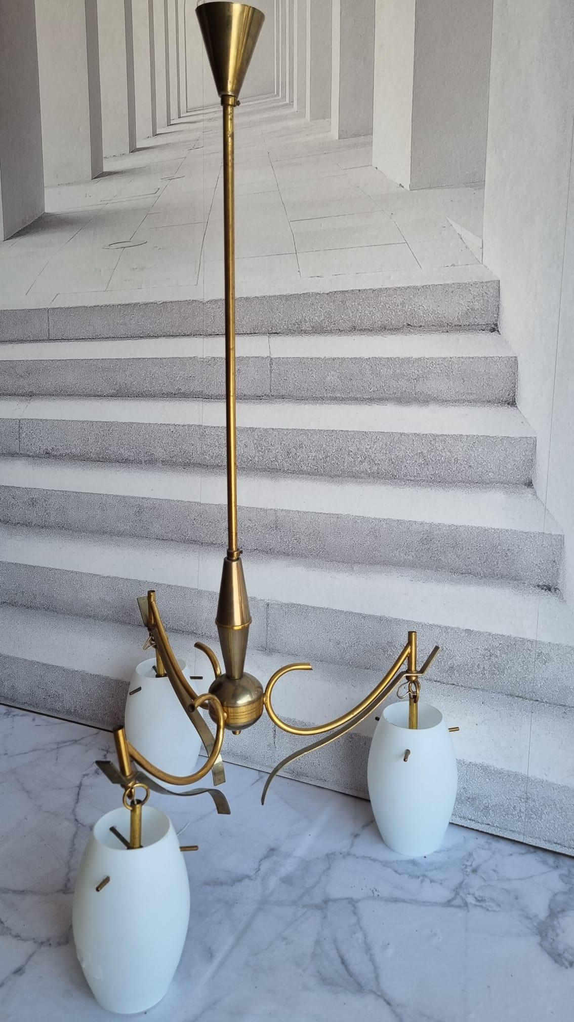 Very decorative and beautiful chandelier made of brass, fitted with three E14 Sockets. Made in Italy in the 1950s, attributed to the famous well known Stilnovo Manufacturer. The Fixture requires three European E14 / 110 Volt Candelabra bulbs, each