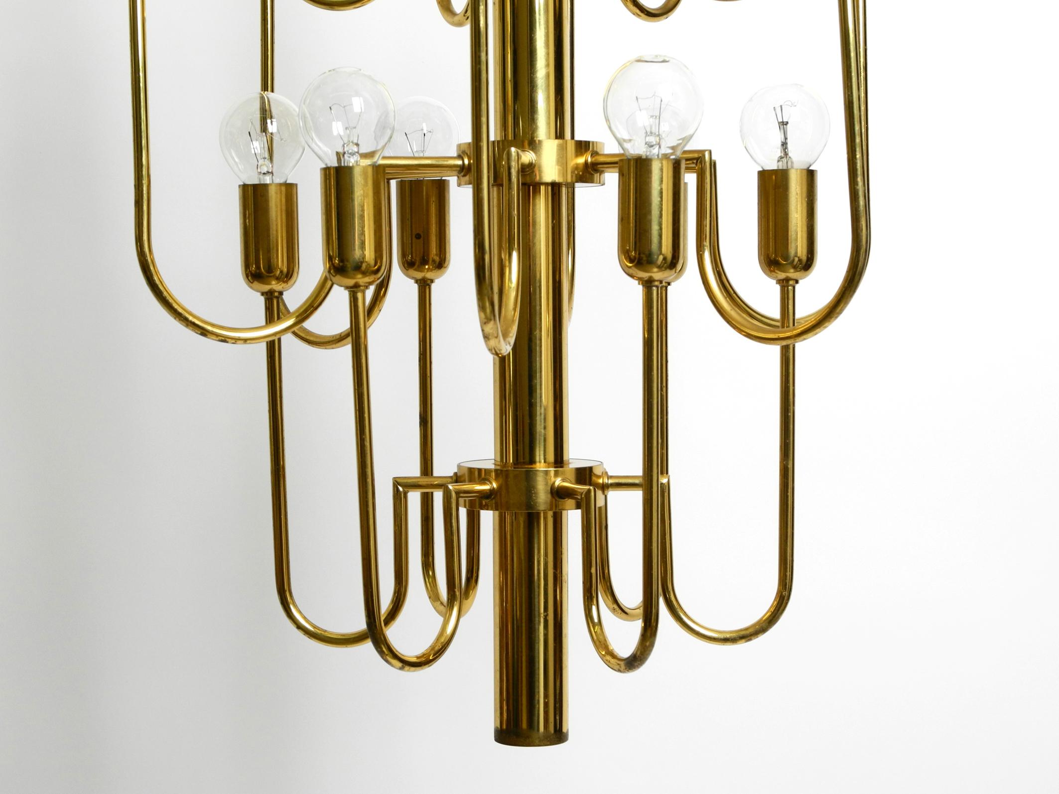 Beautiful three staged 18 arm Mid Century brass chandelier with a long brass rod For Sale 9
