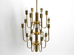 Beautiful three staged 18 arm Mid Century brass chandelier with a long brass rod