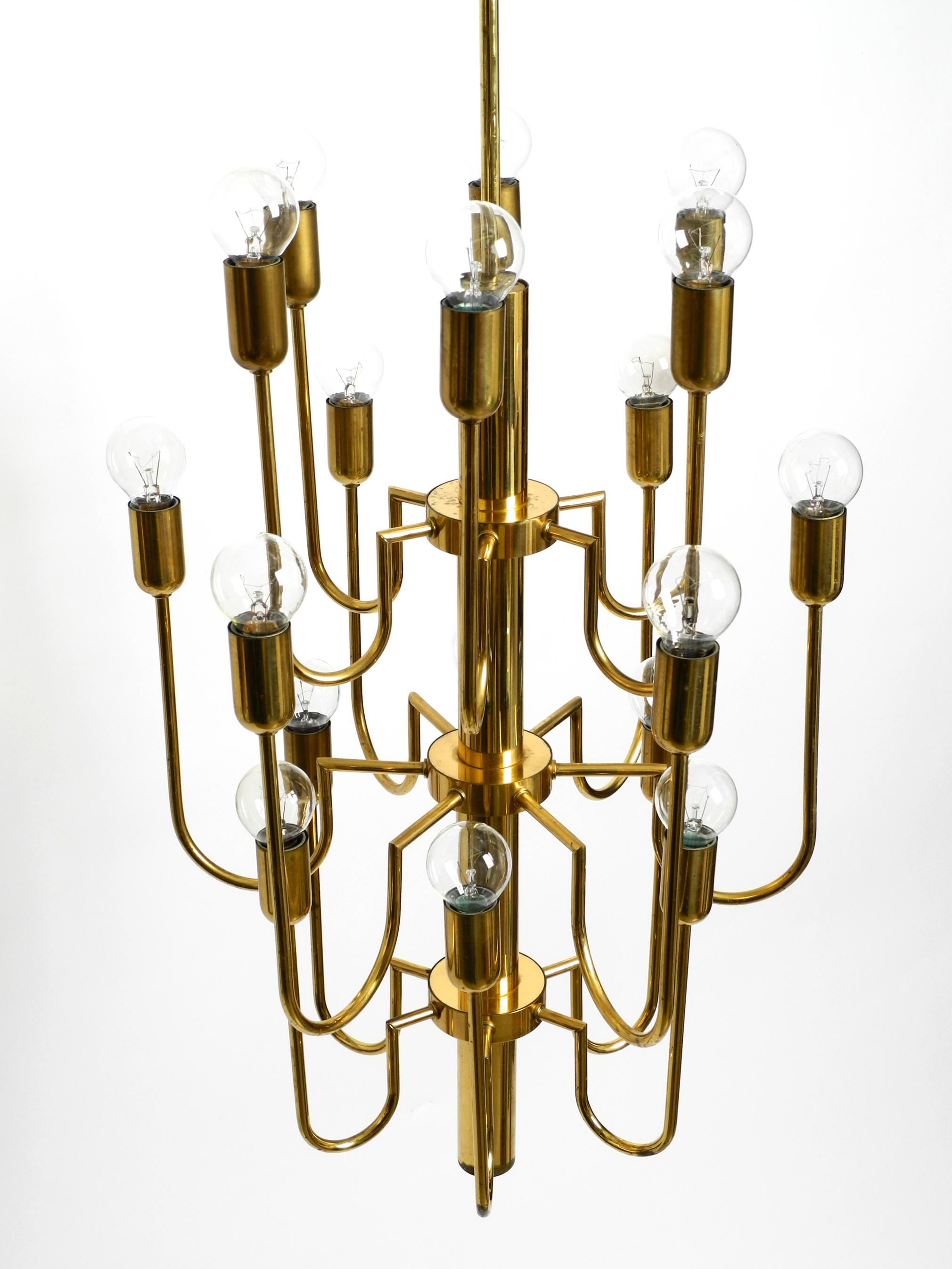 Mid-20th Century Beautiful Three Staged 18 Arm Midcentury Brass Chandelier with a Long Brass Rod For Sale