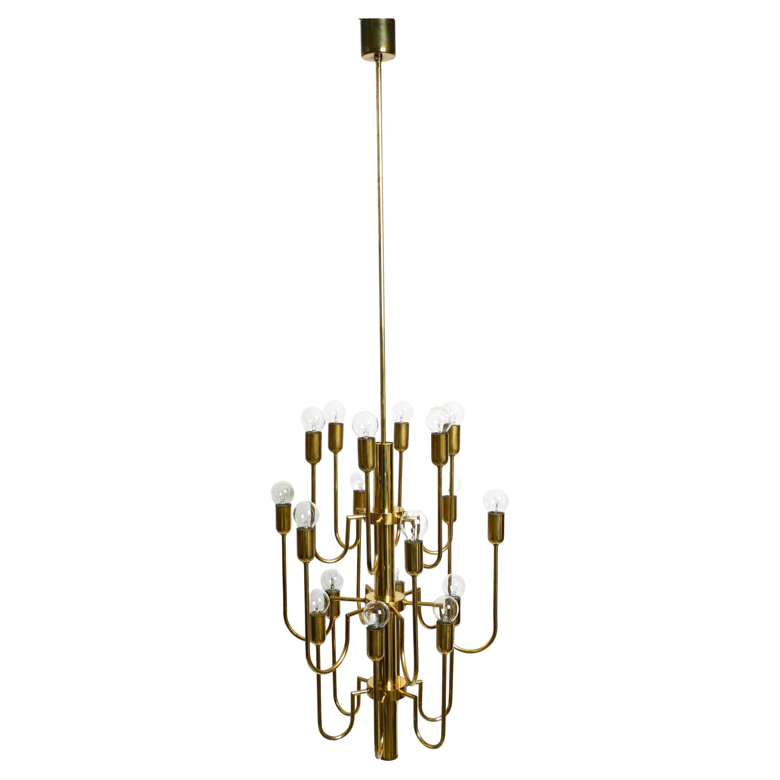 Beautiful Three Staged 18 Arm Midcentury Brass Chandelier with a Long Brass Rod For Sale