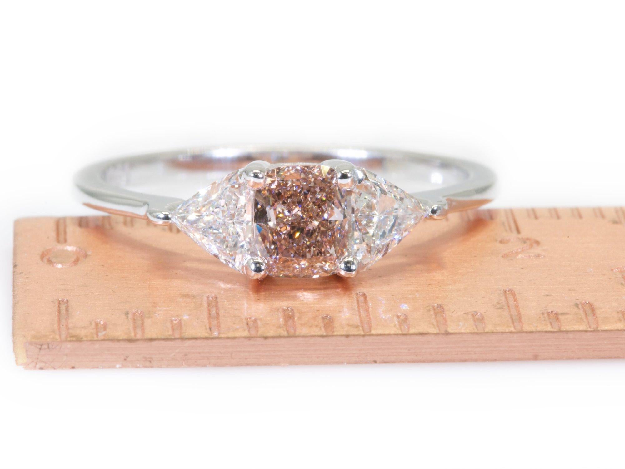Rare and amazing natural pink brown diamond with 2 shine and sparkle Trillions on the side mounted in a Beautiful 18k white gold diamond ring with GIA certificate for the pink diamond.

one of kind ring with 0.82 carat 

Set with:

-1 diamond main
