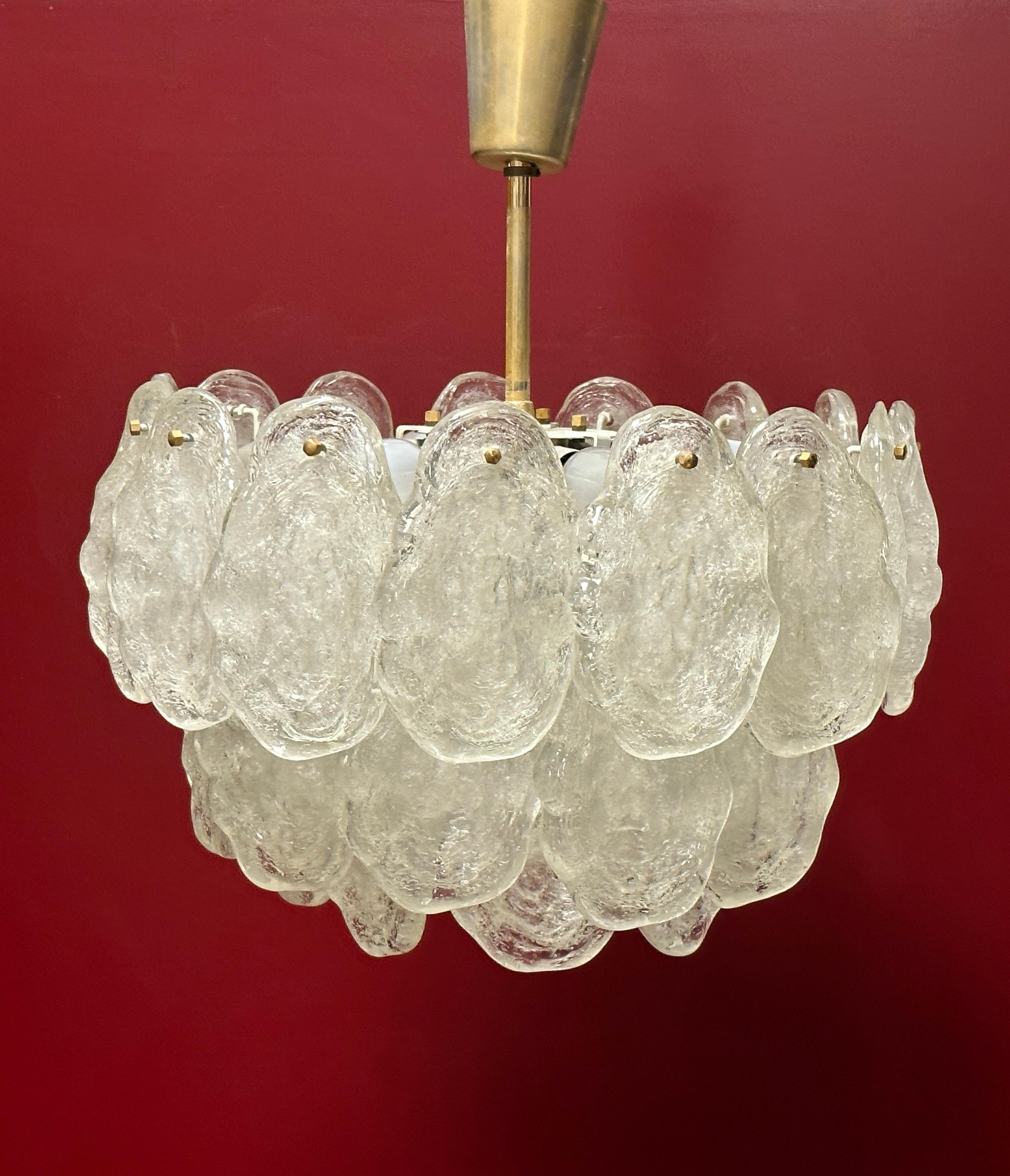 Beautiful and rare chandelier or pendant light by Kalmar Leuchten, Austria. An original mid-century vintage piece manufactured in the 1960s. It is made of brass, metal and Lucite glass. The Fixture requires one European E27 / 110 Volt Edison bulb, p