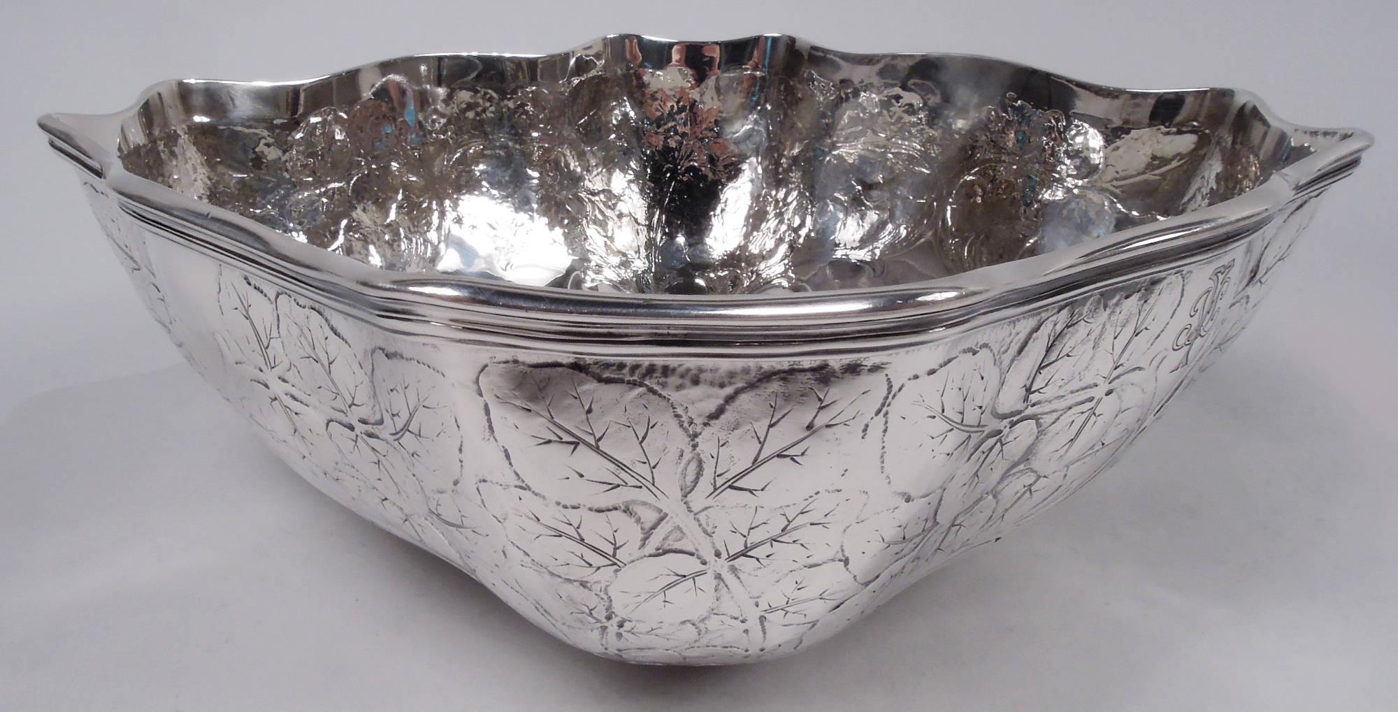 Edwardian Art Nouveau sterling silver bowl. Made by Tiffany & Co. in New York, ca 1907. Four curved and wavy sides with concave corners and molded rim. On exterior are acid-etched ogee frames (vacant) surmounted by dense leafing branches. Engraved