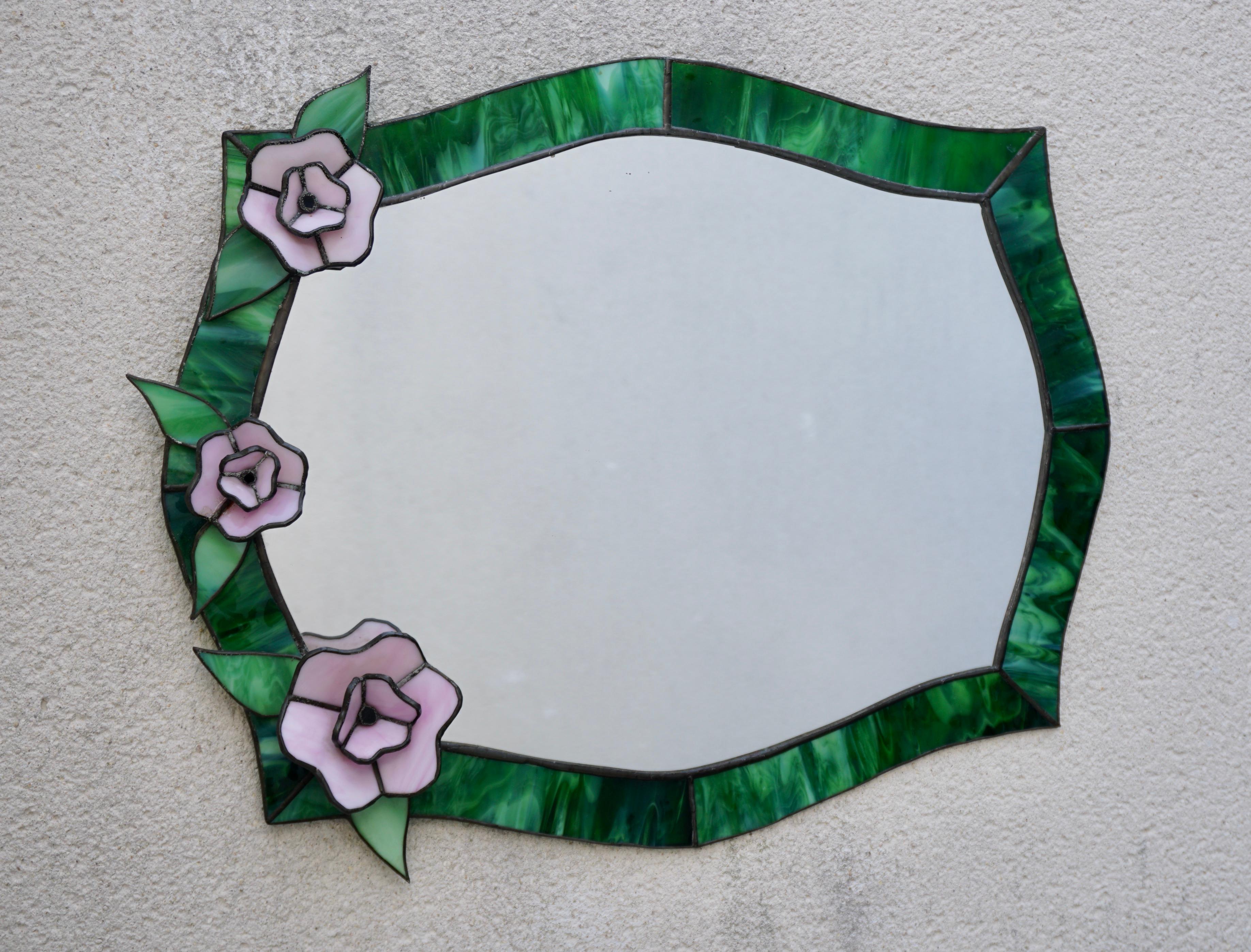 Beautiful green Tiffany stained glass mirror with pink flowers.

Width 20.8