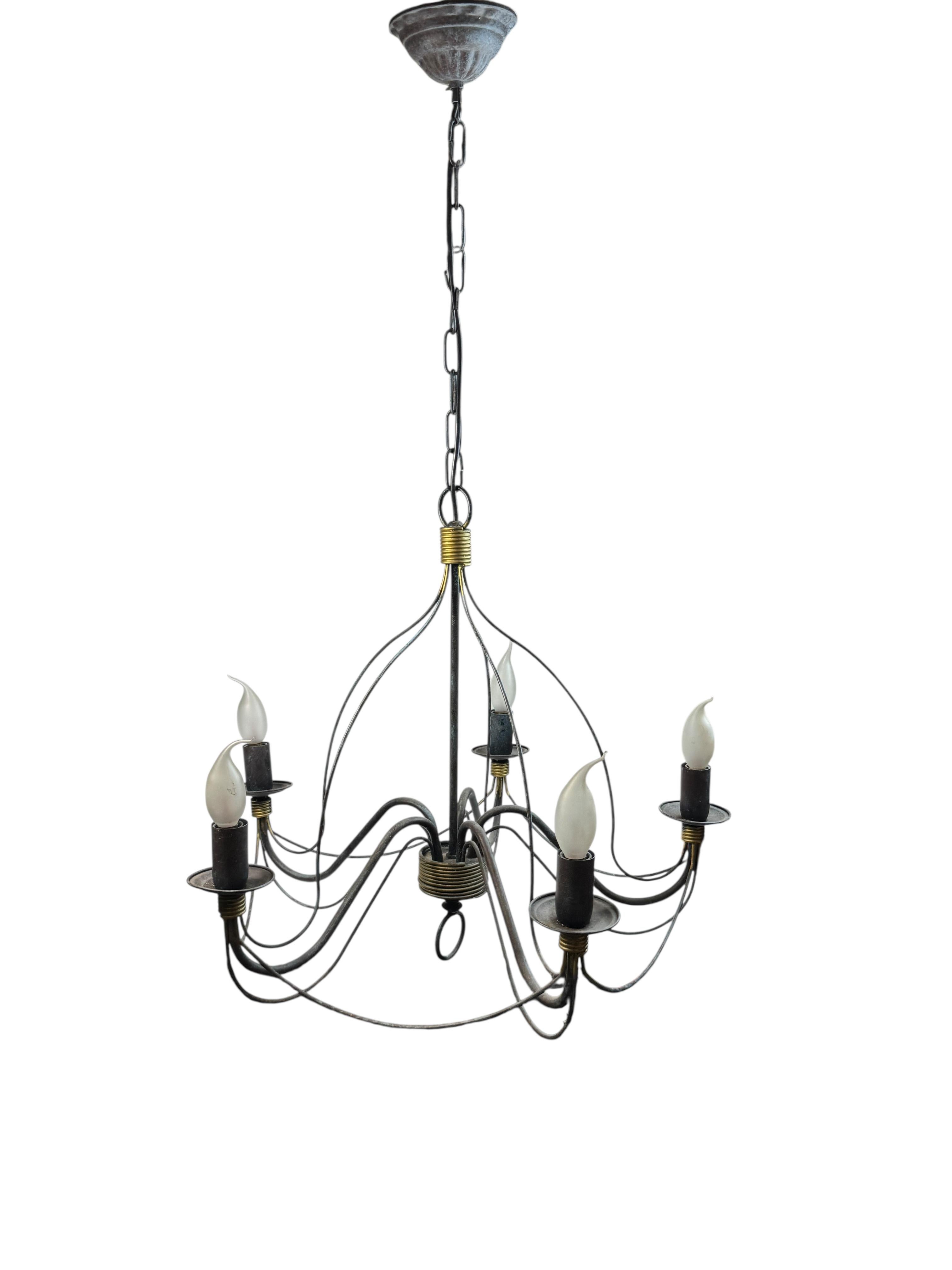 Petite Florentine style five-light chandelier. The Fixture requires five European E14 / 110 Volt Candelabra bulbs, each bulb up to 40 watts. Beautiful metal chandelier black weathered verdigris and gilded parts. It gives a very warm light and
