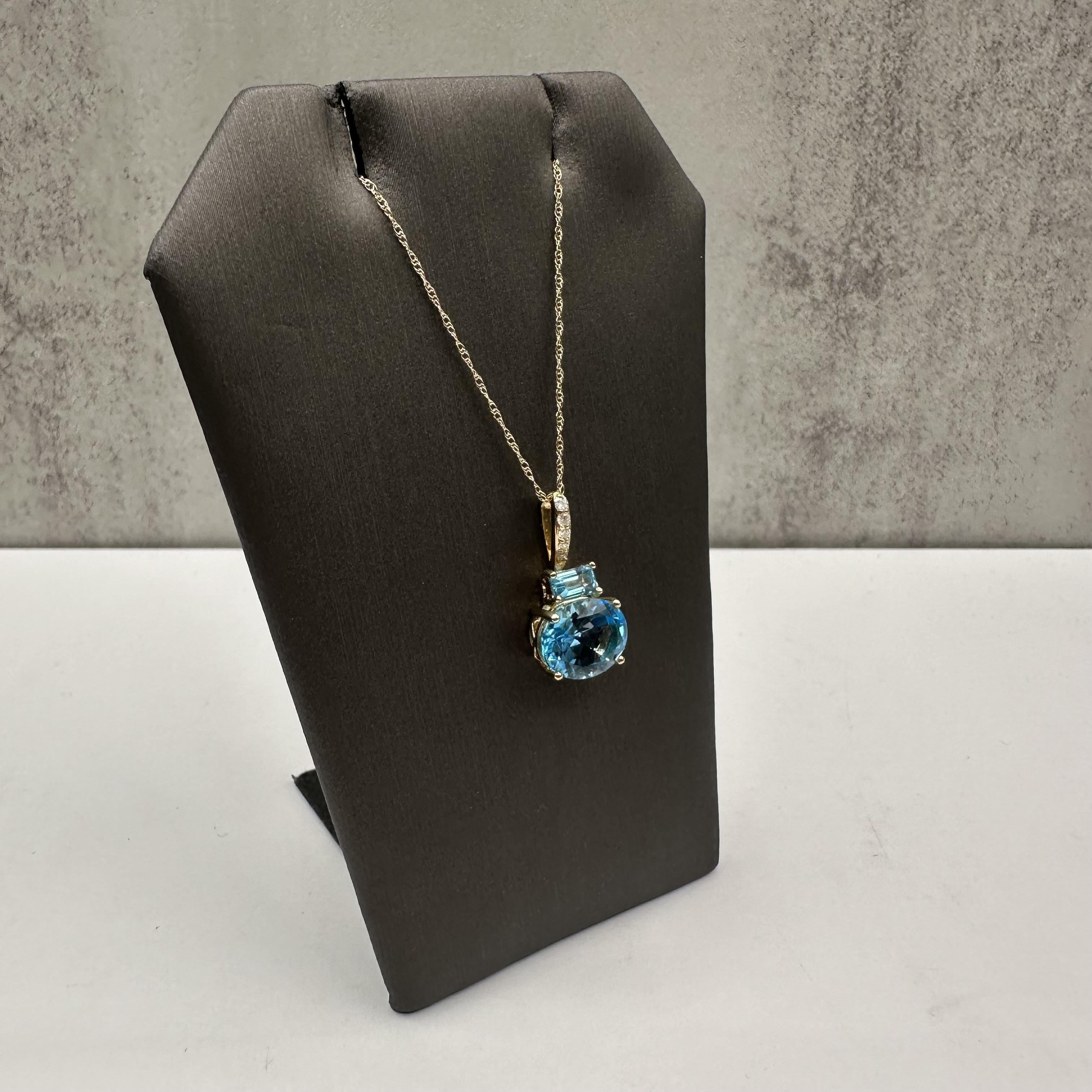 Add a touch of elegance and color to your collection with this Topaz and Diamond Necklace, crafted in 10kt Yellow Gold. This necklace showcases a stunning 10x8mm oval blue topaz paired with a 5x3mm emerald-cut topaz, offering a beautiful mix of