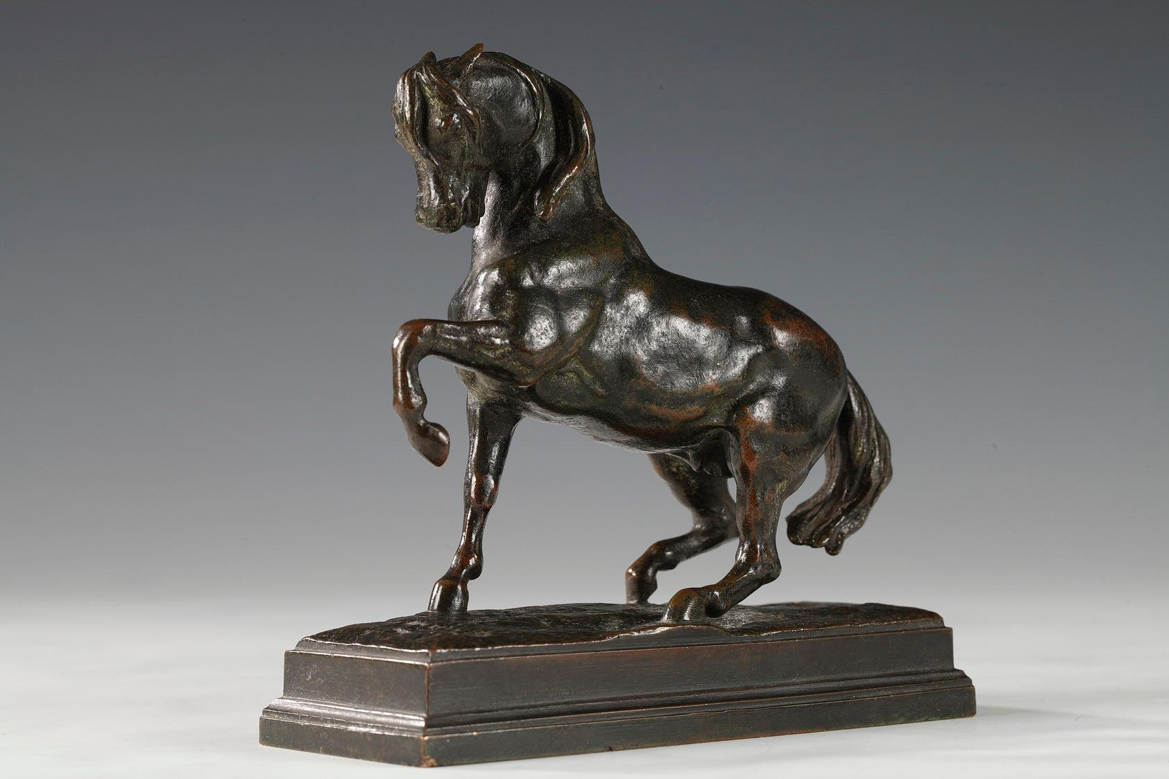Green patina bronze of a horse with left foreleg raised on rectangular base. The cast is signed BARYE and inscribed by the founders F. BARBEDIENNE. FONDEUR. The powerful modelling of the animal reflects his strength.

This is a smaller reproduction