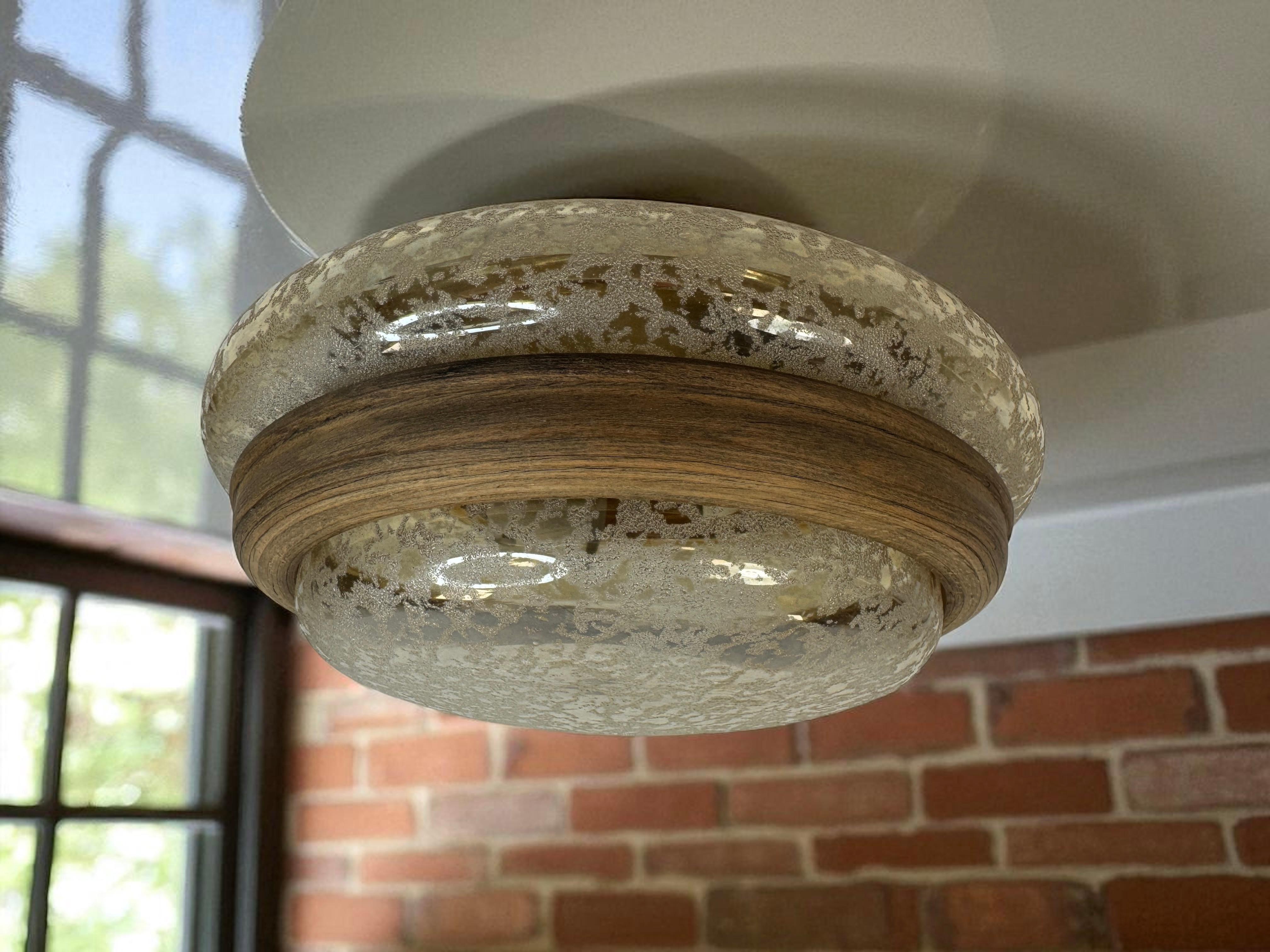Beautiful organic glass flush mount. Made in Germany by Glashütte Limburg. Gorgeous textured light amber colored glass flush mount with metal fixture and wooden frame. The fixture requires two European E27 Edison or medium bulb up to 60 watts each.