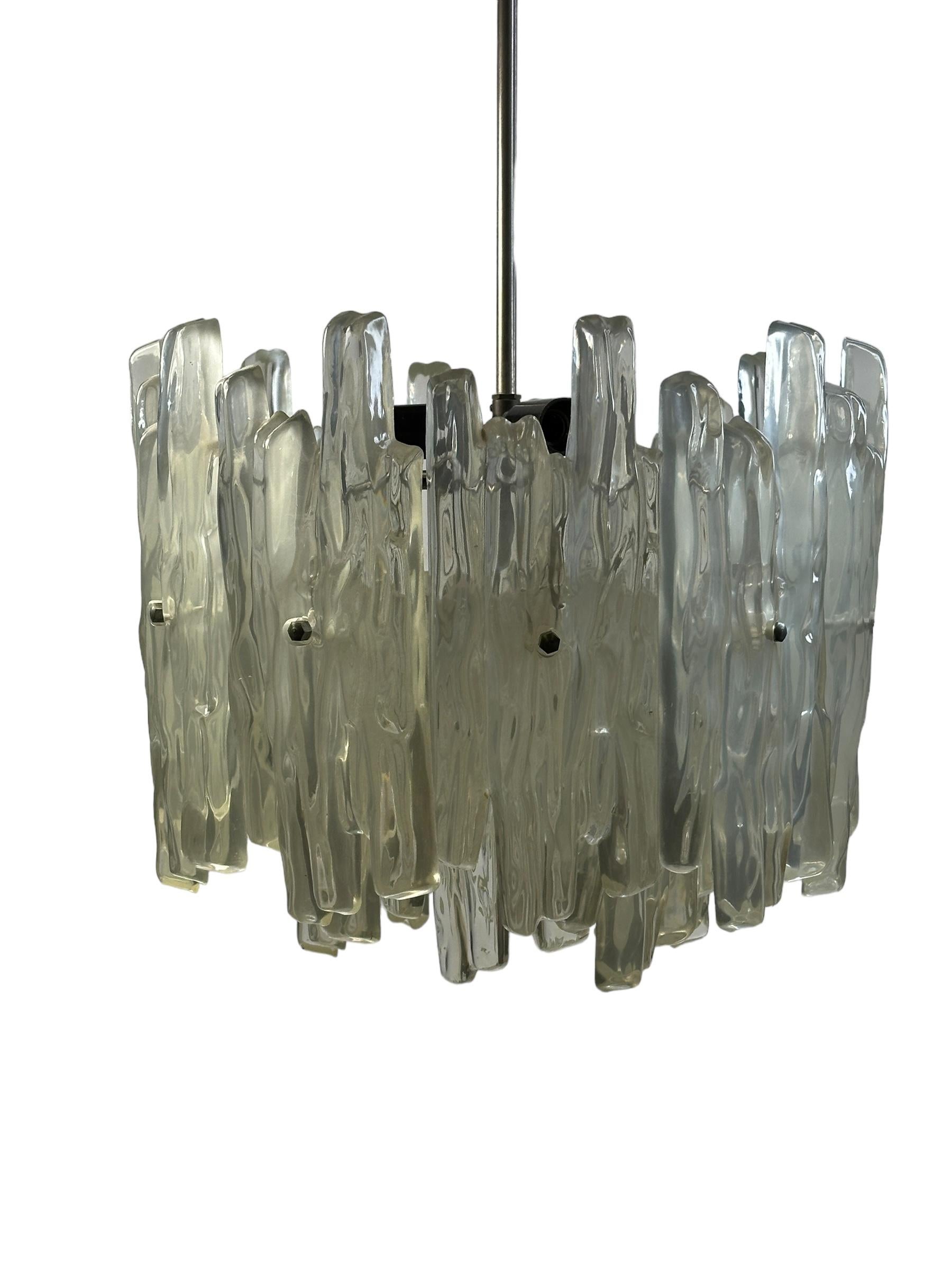 Beautiful and rare chandelier or pendant light by Kalmar Leuchten, Austria. An original mid-century vintage piece manufactured in the 1960s. It is made of aluminum , metal and Lucite glass. The Fixture requires one European E27 / 110 Volt Edison