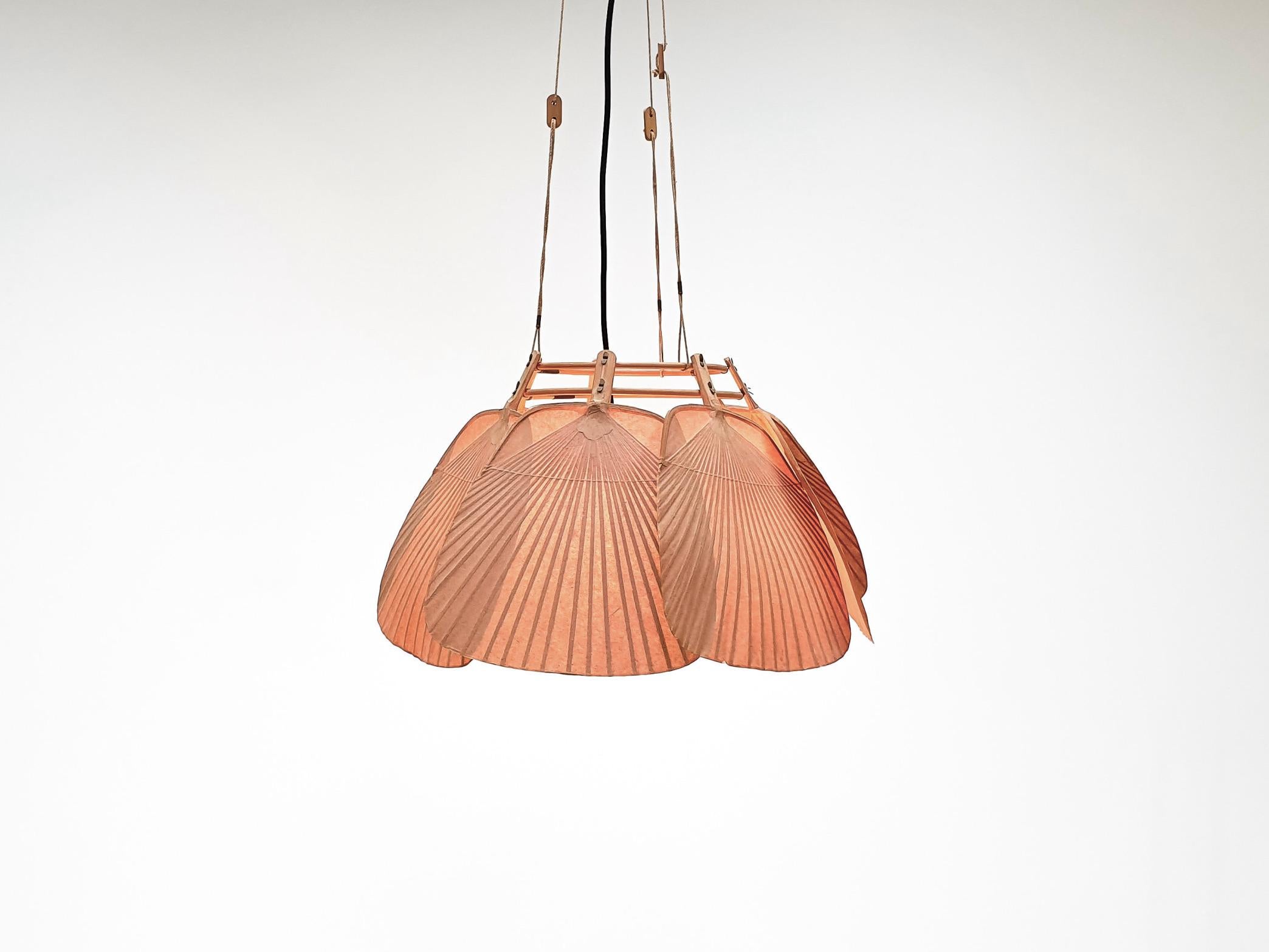 Rare Uchiwa Ju-Yon chandelier in very good condition. 

Designed by Ingo Maurer for M design, Germany. 

This chandelier is handmade from bamboo and Japanese rice paper. 

The lamp consists of seven fans hanging from a bamboo frame. 

When